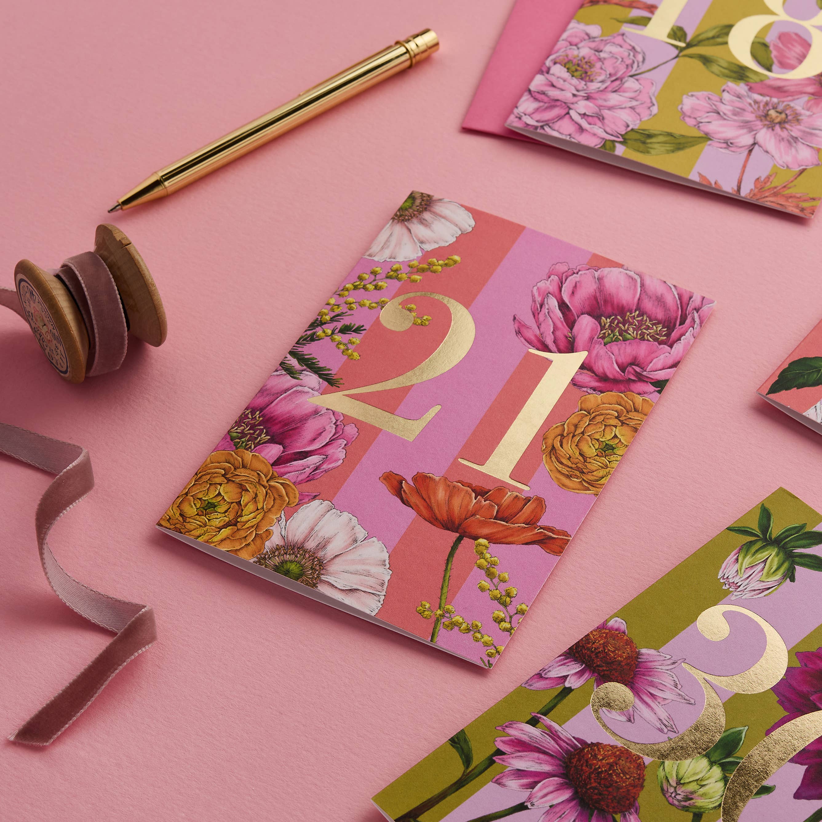 Floral-themed cards with numbers on a pink background.