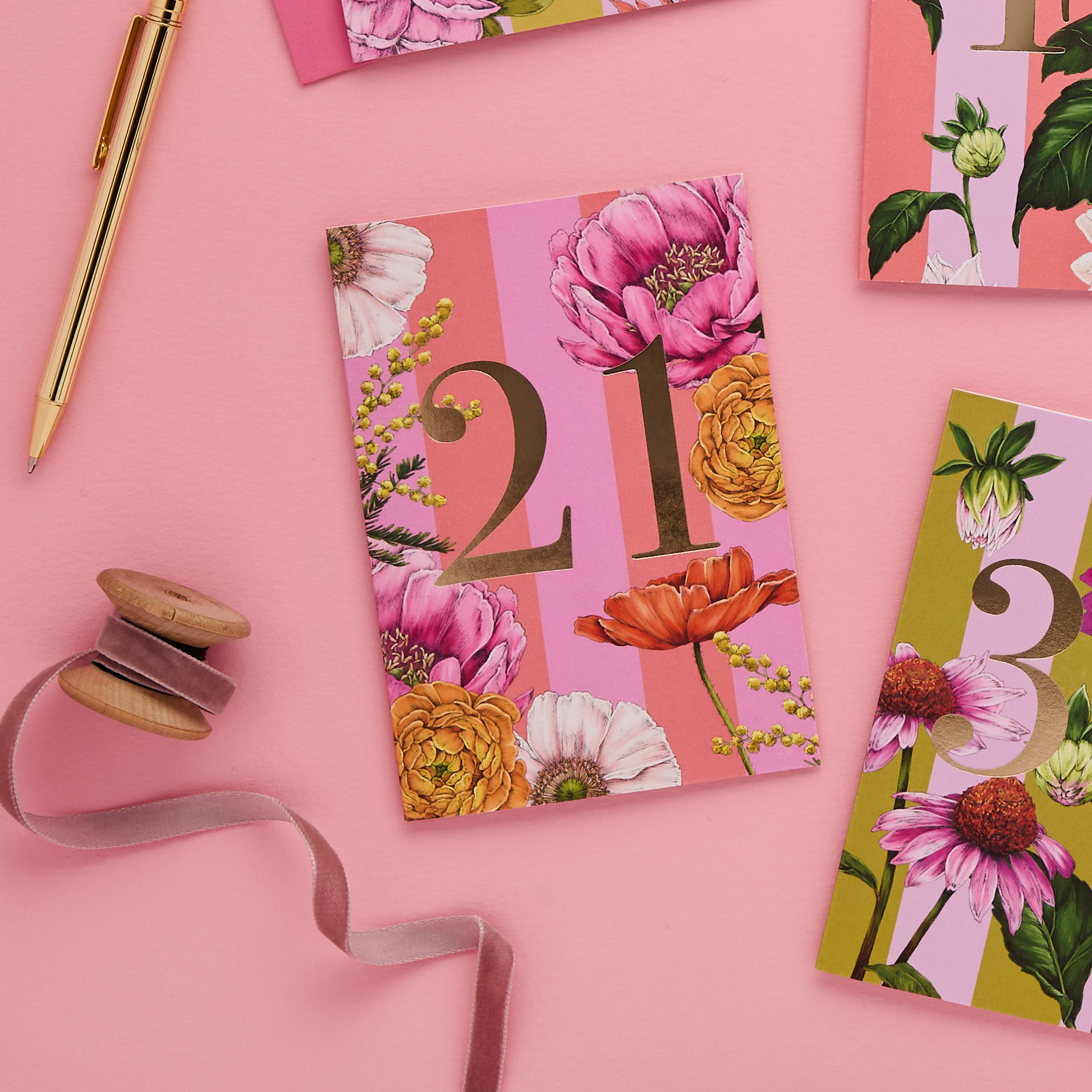 Floral-themed cards with numbers on a pink background.