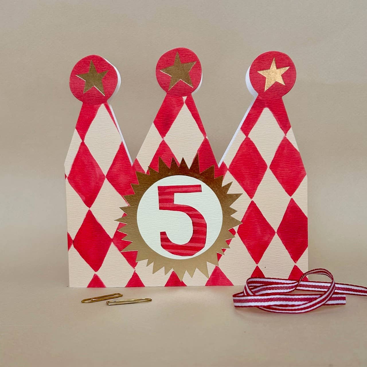 Decorative birthday card with number 5, red and white pattern, and gold accents on a beige background.