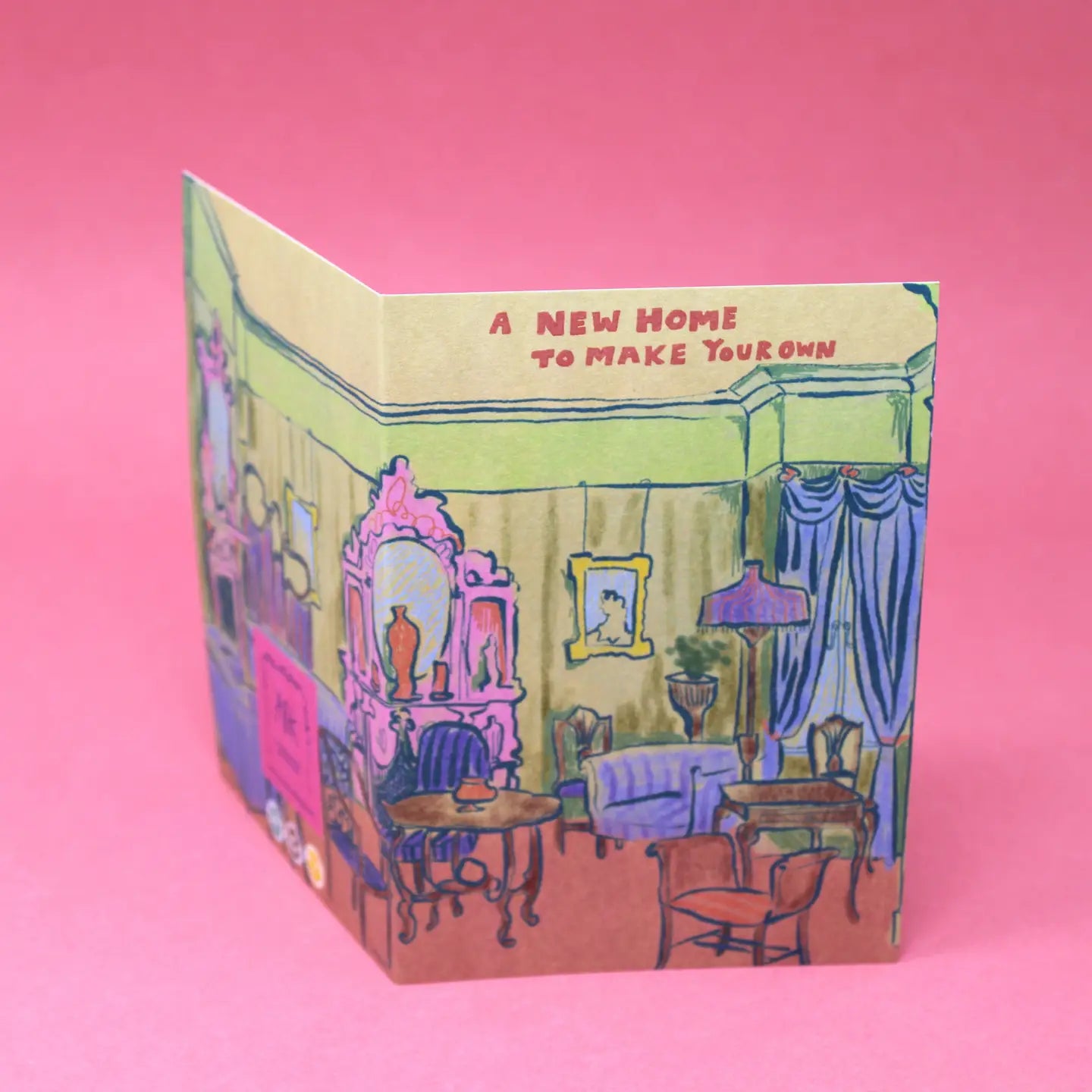 Greeting card with illustration of a living room and text 'A New Home To Make Your Own' on a pink background.