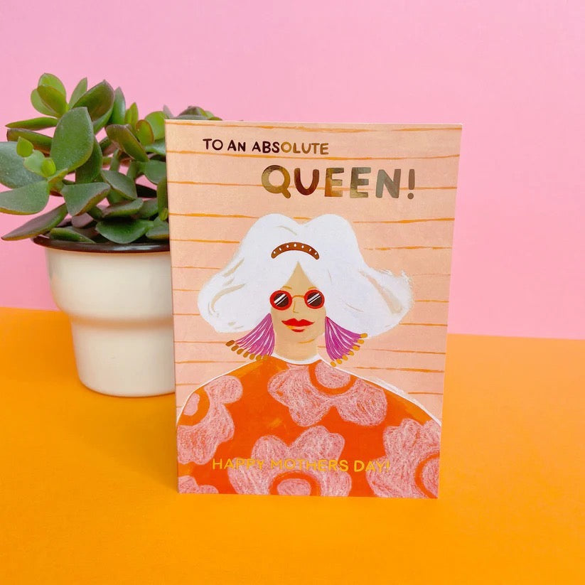 Greeting card with illustration of a woman and text 'To an absolute queen! Happy Mother's Day' on a pink and orange background.