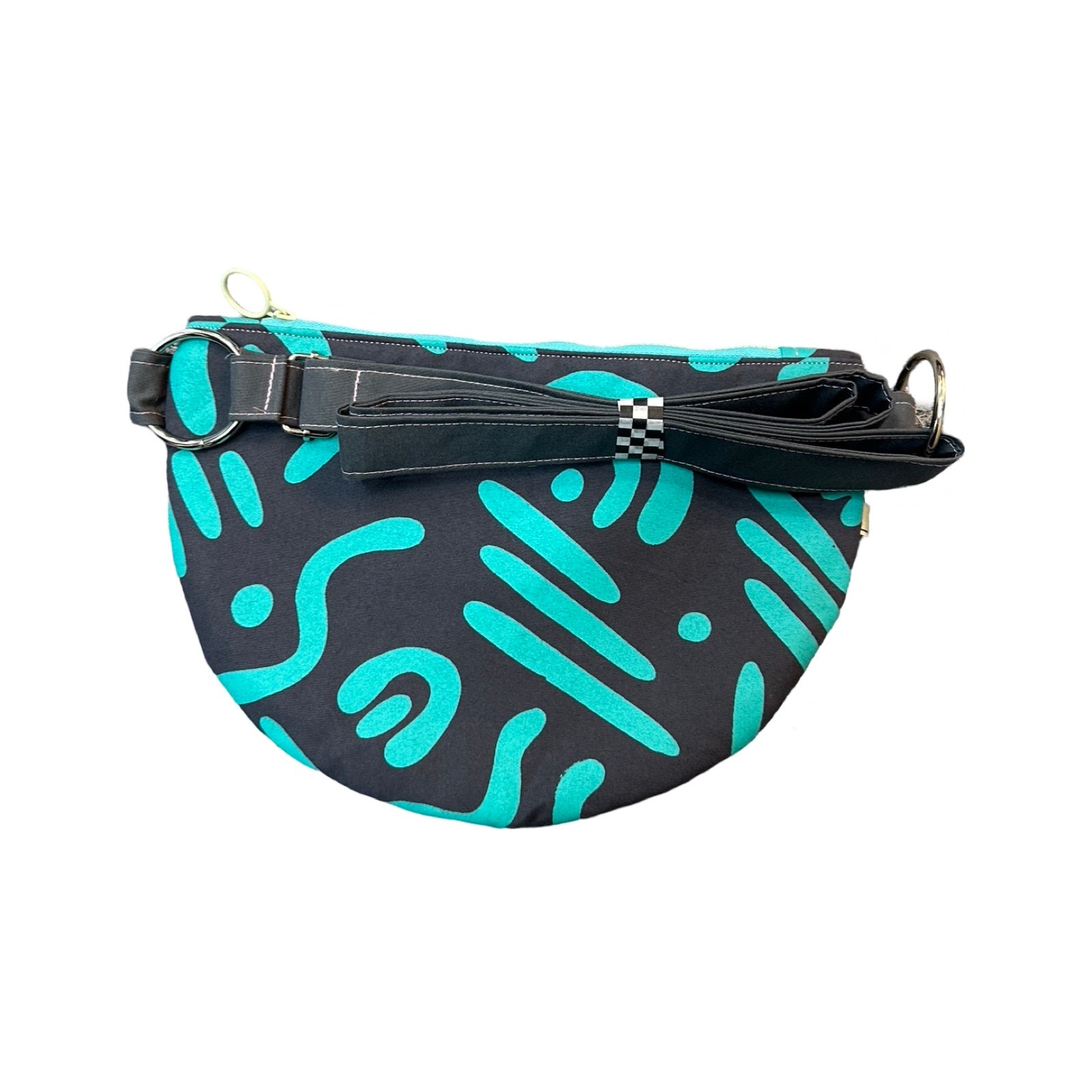 a turquoise and grey cross-body bag in an abstract design with an adjustable strap.
