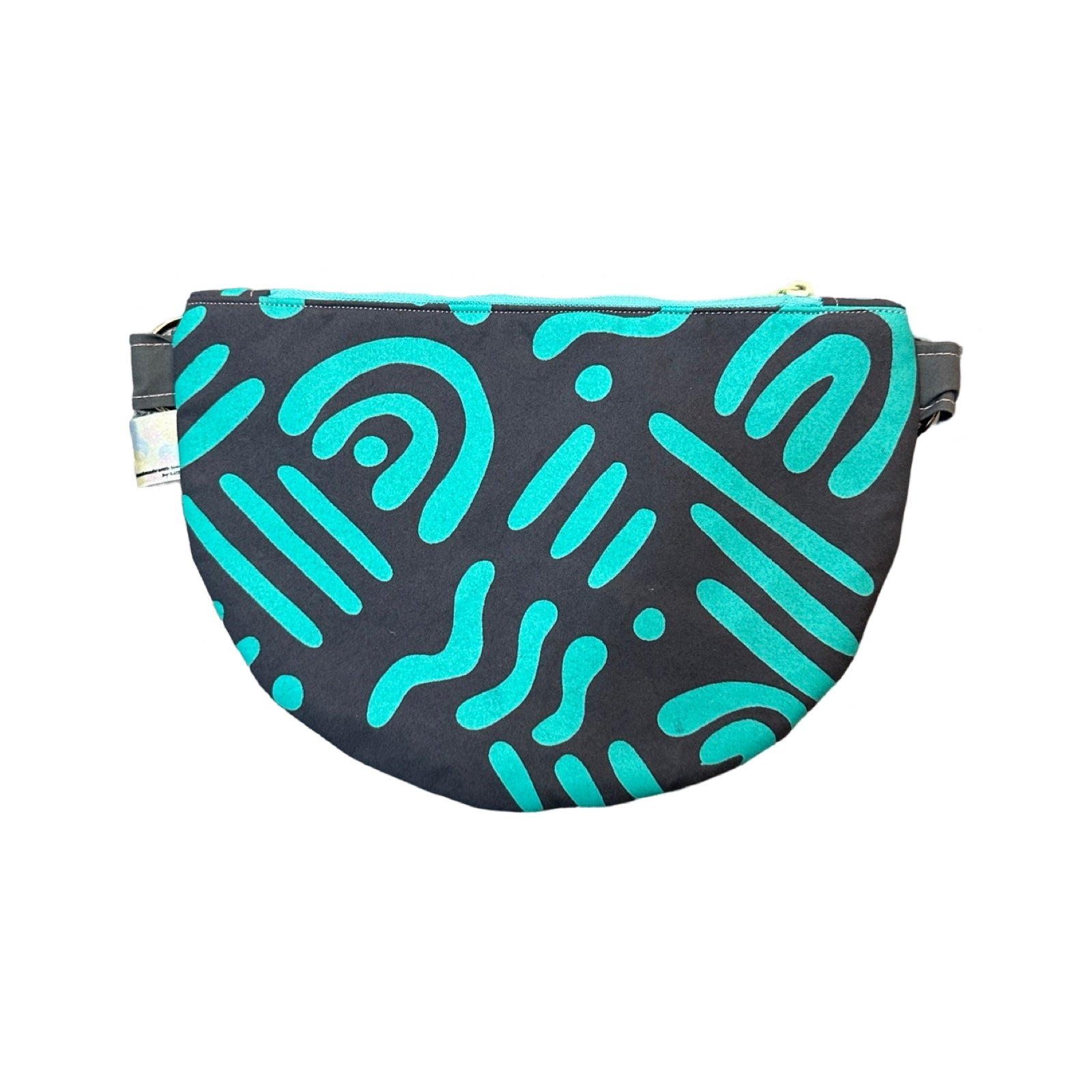 a turquoise and grey cross-body bag in an abstract design.
