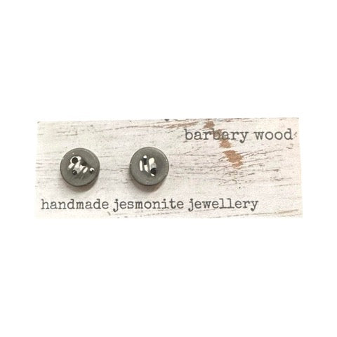 Grey round stud earrings with a black and white abstract pattern.