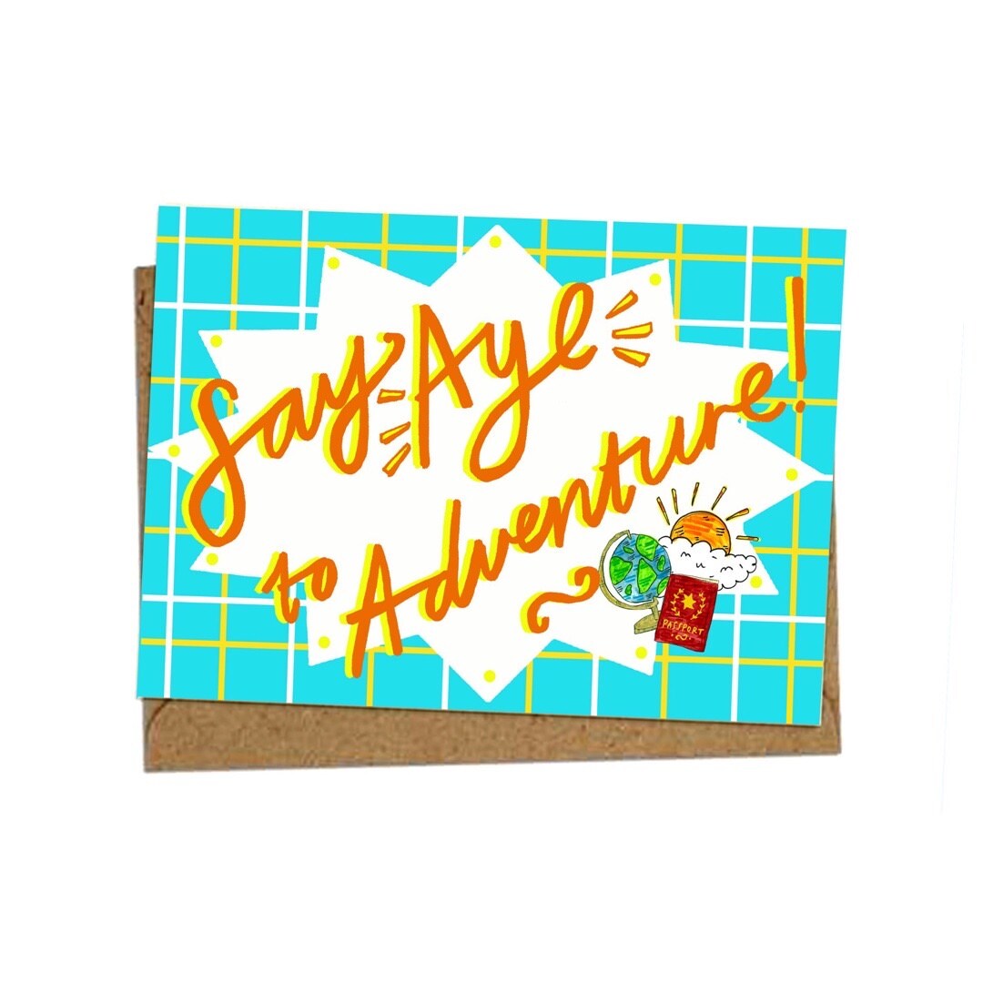 A card for the adventurer in your life with the text 'Say Aye To Adventure' with an illustration of a globe, a passport and the sun on a blue checked background.