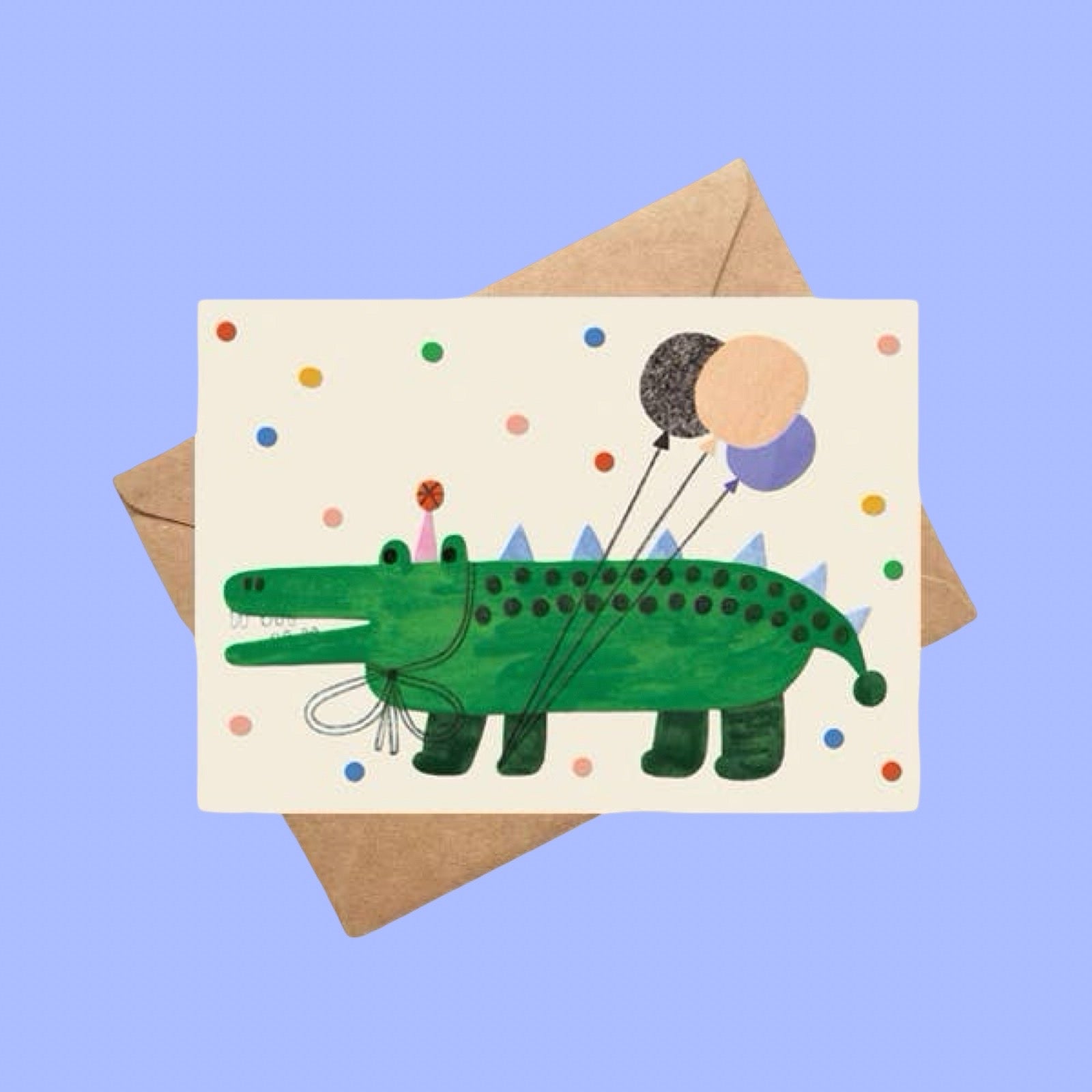 Card with a green alligator illustration holding balloons on a blue background.