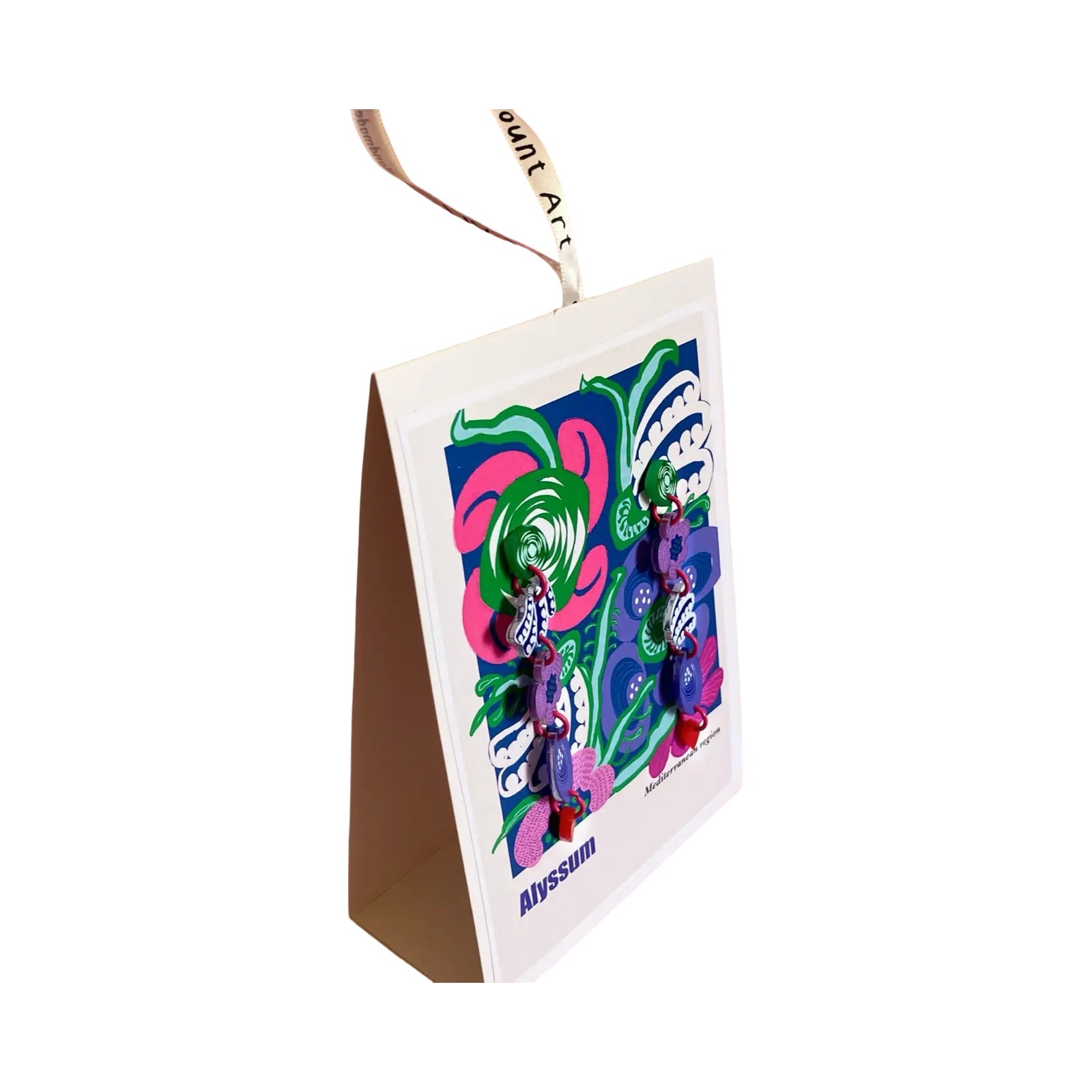 A pair of acrylic dangle earrings with green squares, pink flowers, navy and white leaves and blue leaves on a matching backing card.