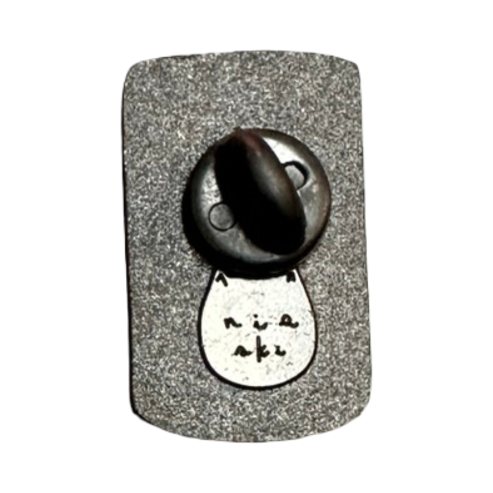 The metal back of a soup can shaped enamel pin badge with a black rubber clasp.