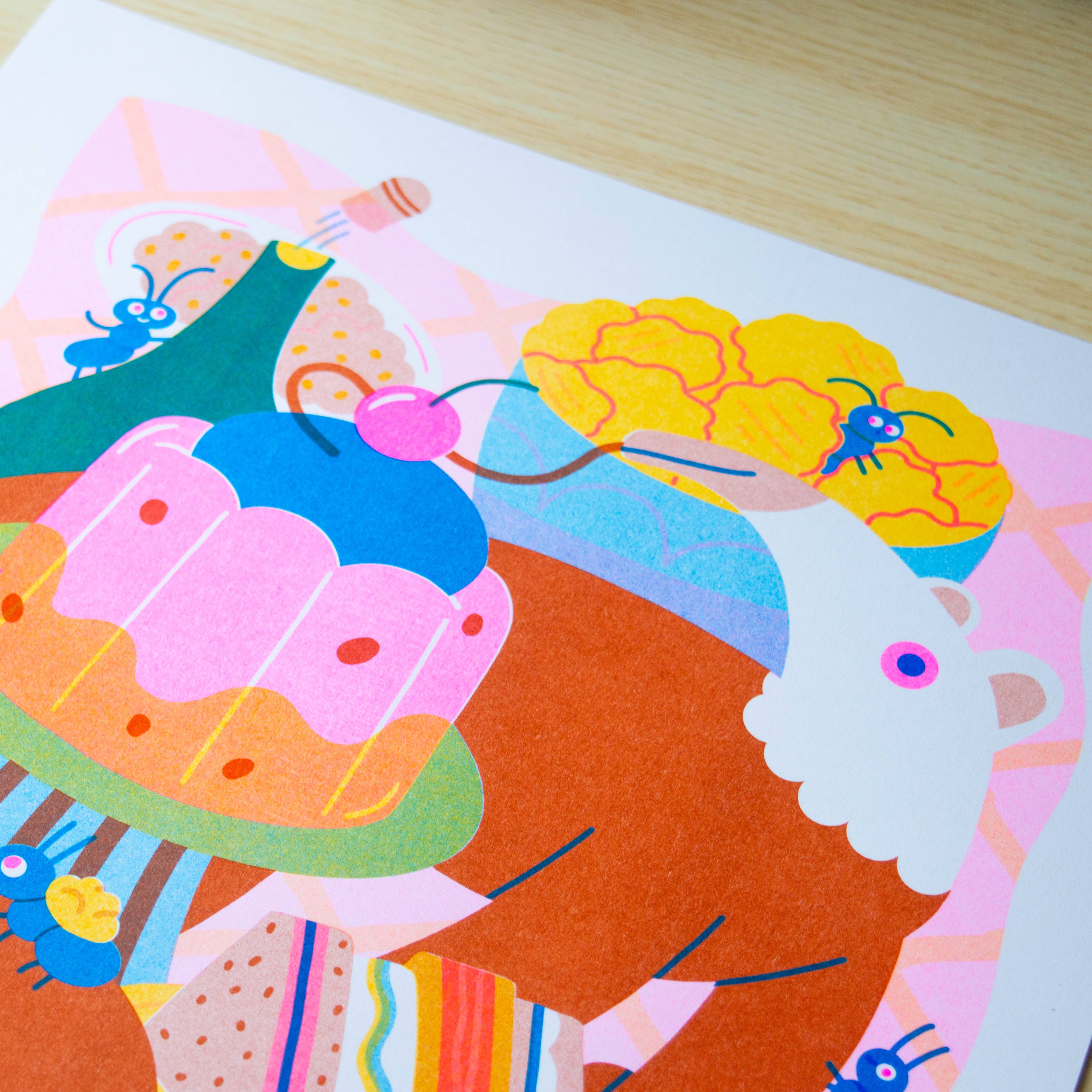 Colourful abstract art piece on a wooden surface.
