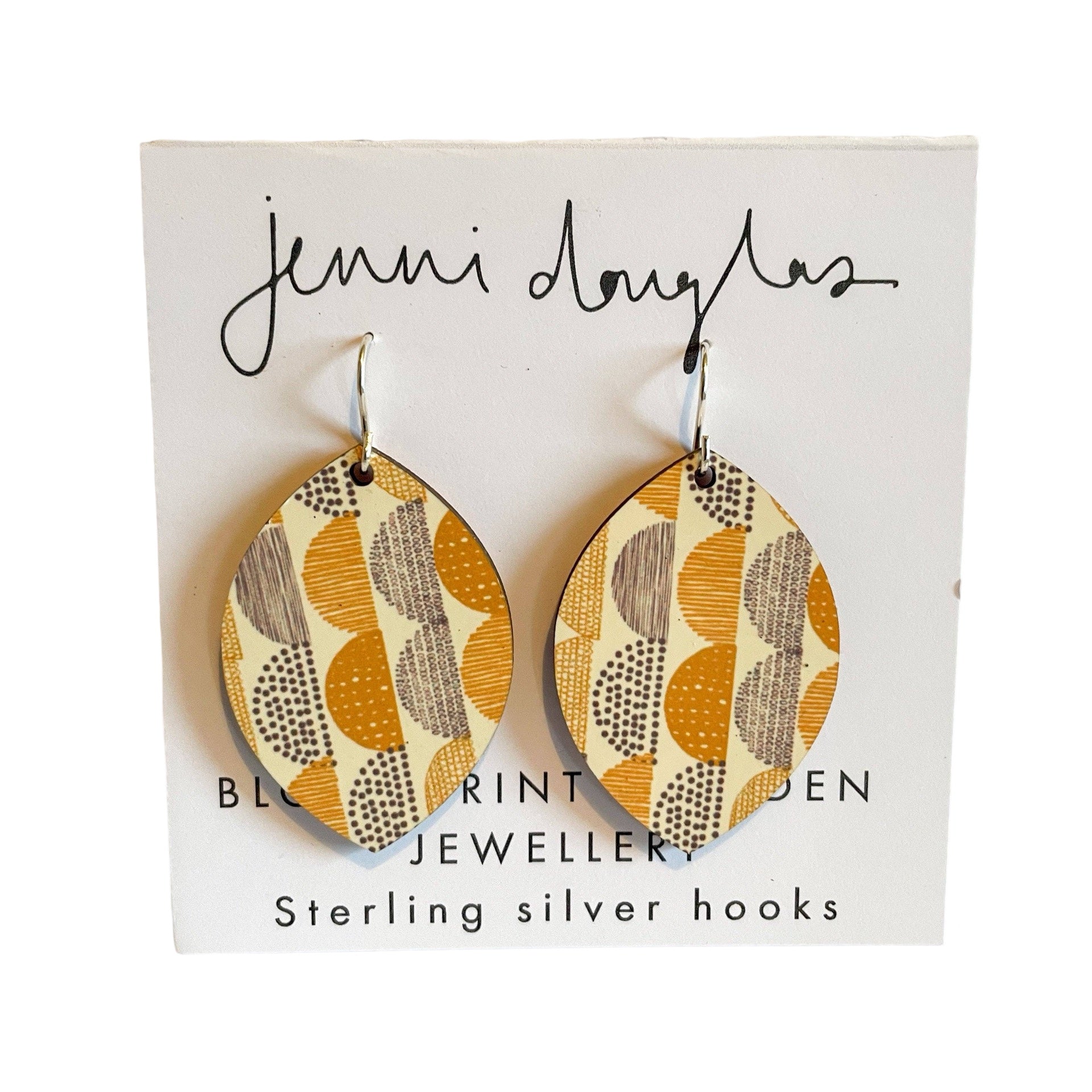 Petal-shaped drop earrings featuring a grey and mustard arcs design made from lightweight, hypo-allergenic aluminium with Sterling Silver hooks, packaged.