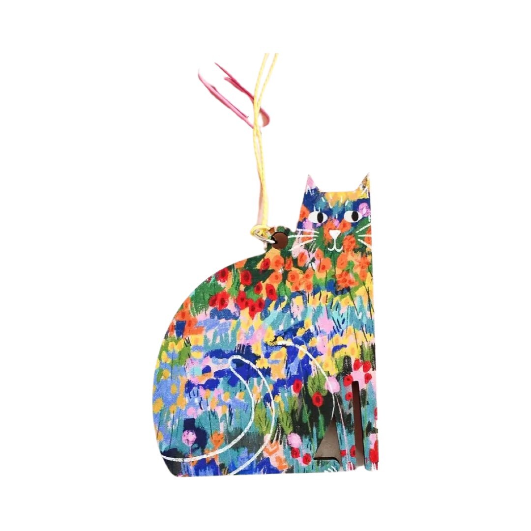 Cat-shaped wooden decoration featuring an illustration of colourful flowers in a garden, inspired by the Vincent Van Gogh painting 'The Garden at Arles'.