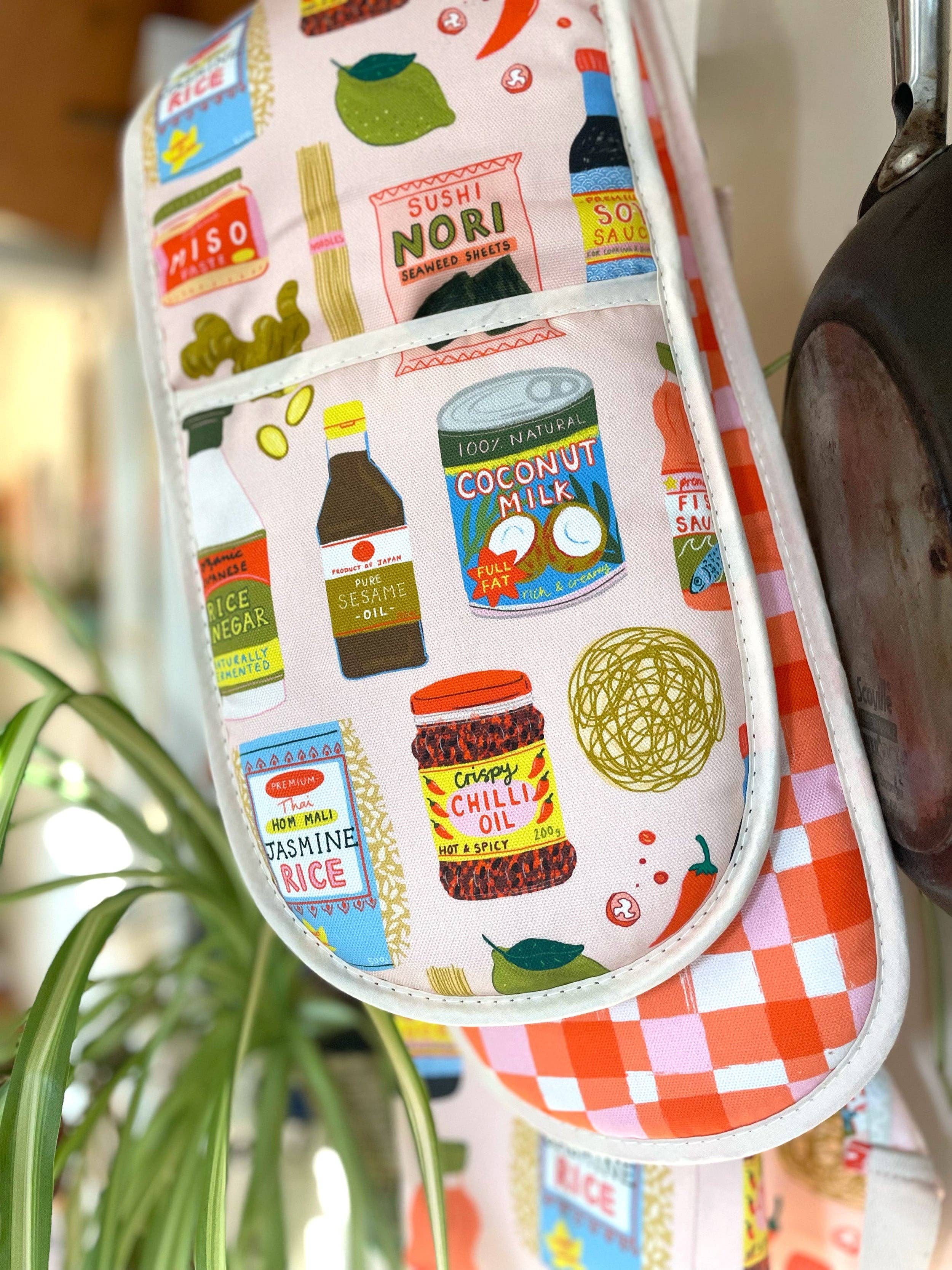 Oven mitt with food-themed design featuring various ingredients and labels.