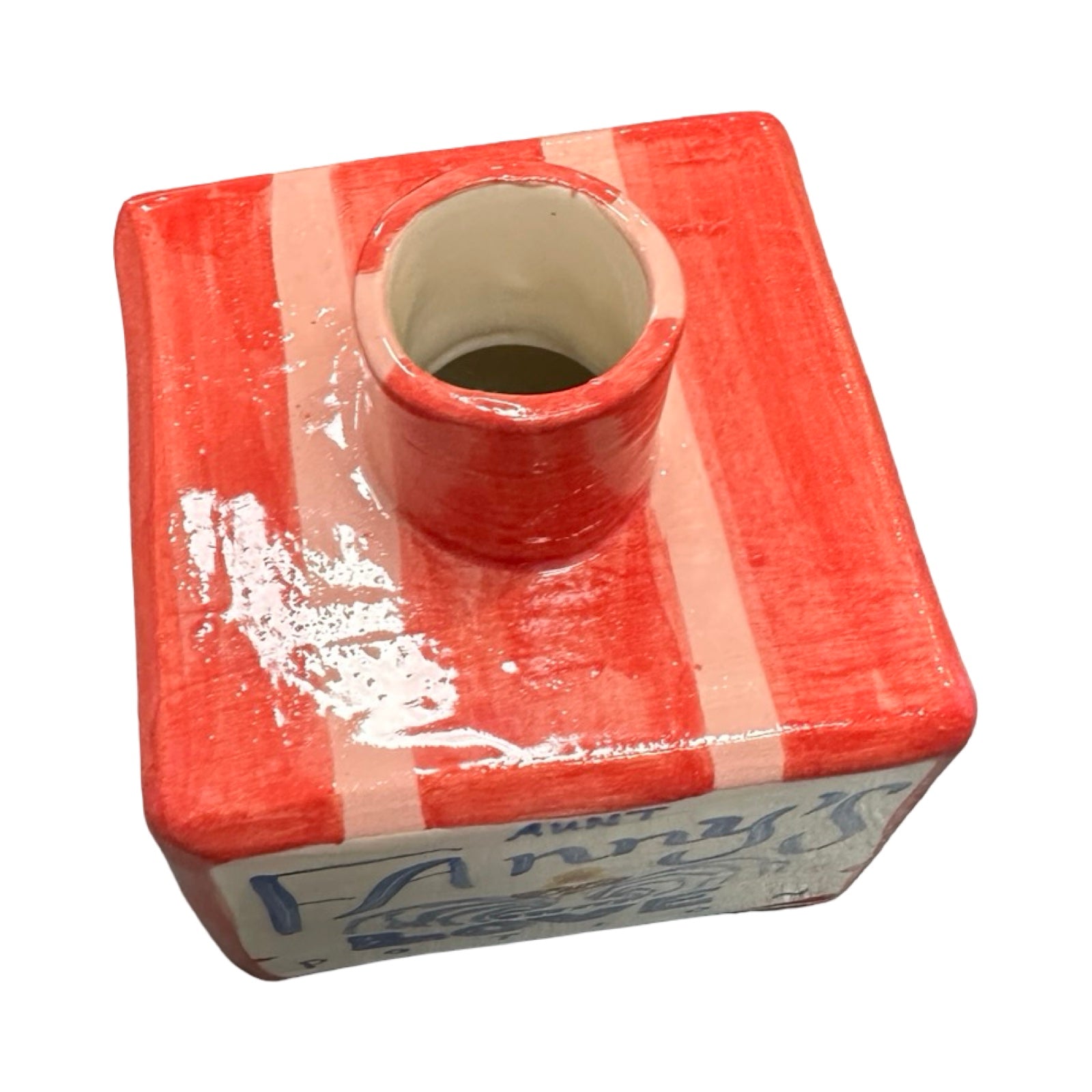 Red and white striped vase with a cylindrical hole on a white background.