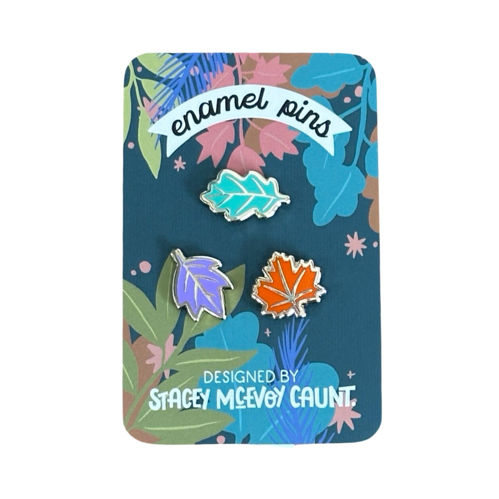 A set of three leaf-shaped enamel pin badges, one green, one orange and one lilac.