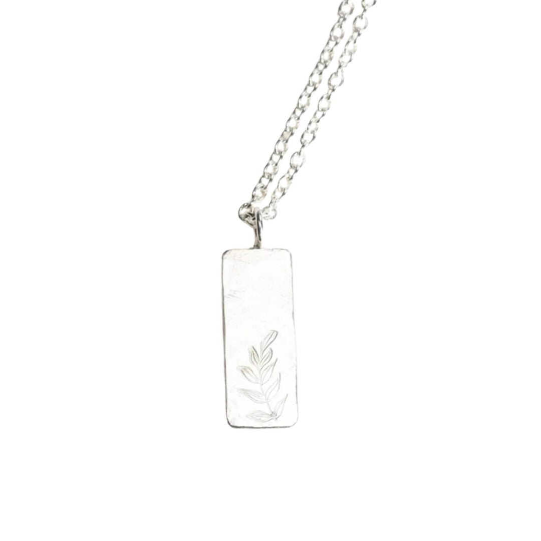Handcrafted recycled sterling silver necklace. 8mm x 21mm pendant has a beaten texture and is imprinted with a delicate fern design.