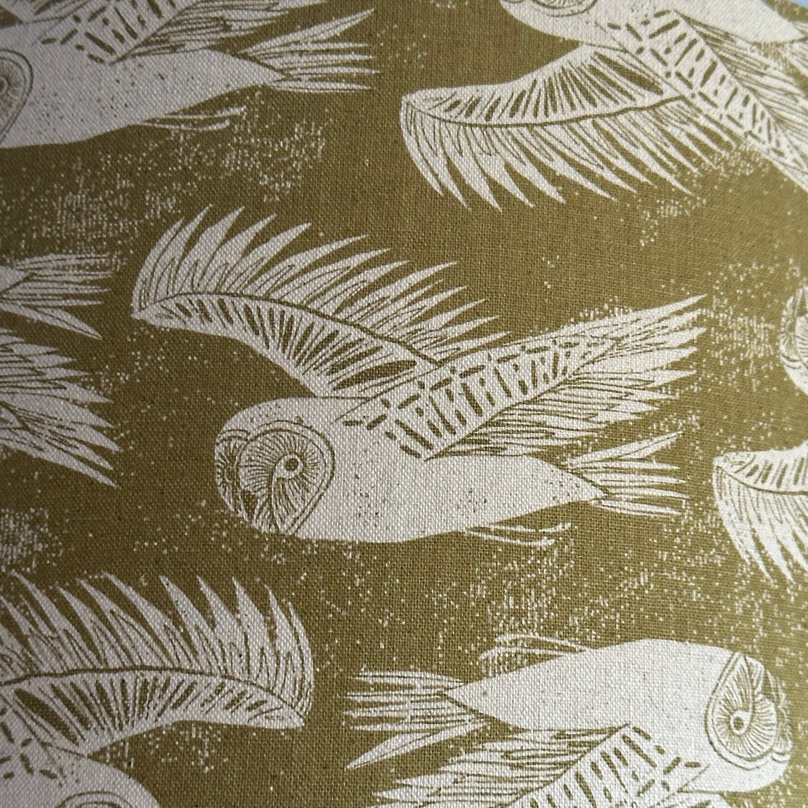 Olive green-coloured cotton/linen blend fabric with cream flying barn owls.