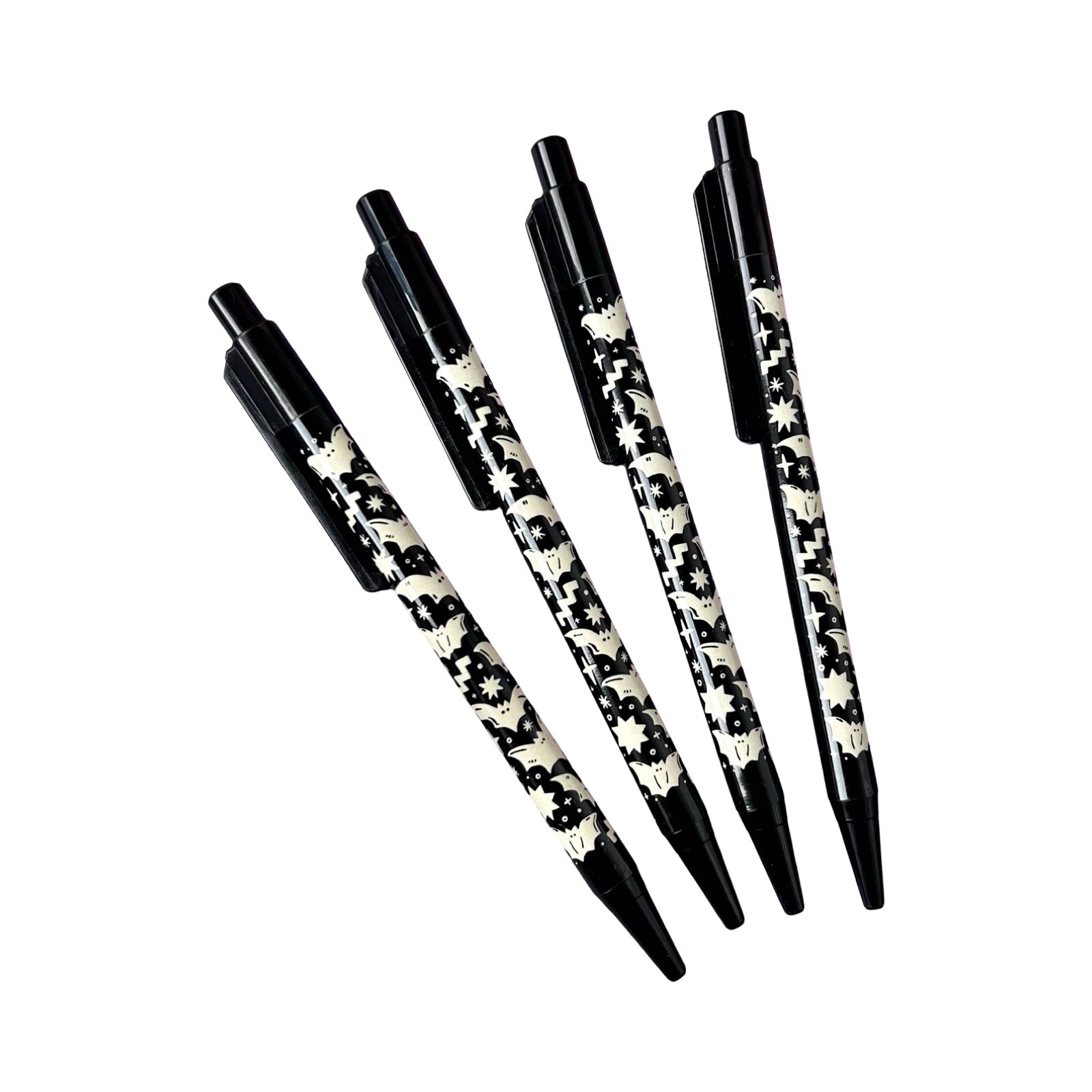 Four ballpoint pens with a white bat design against a black background.