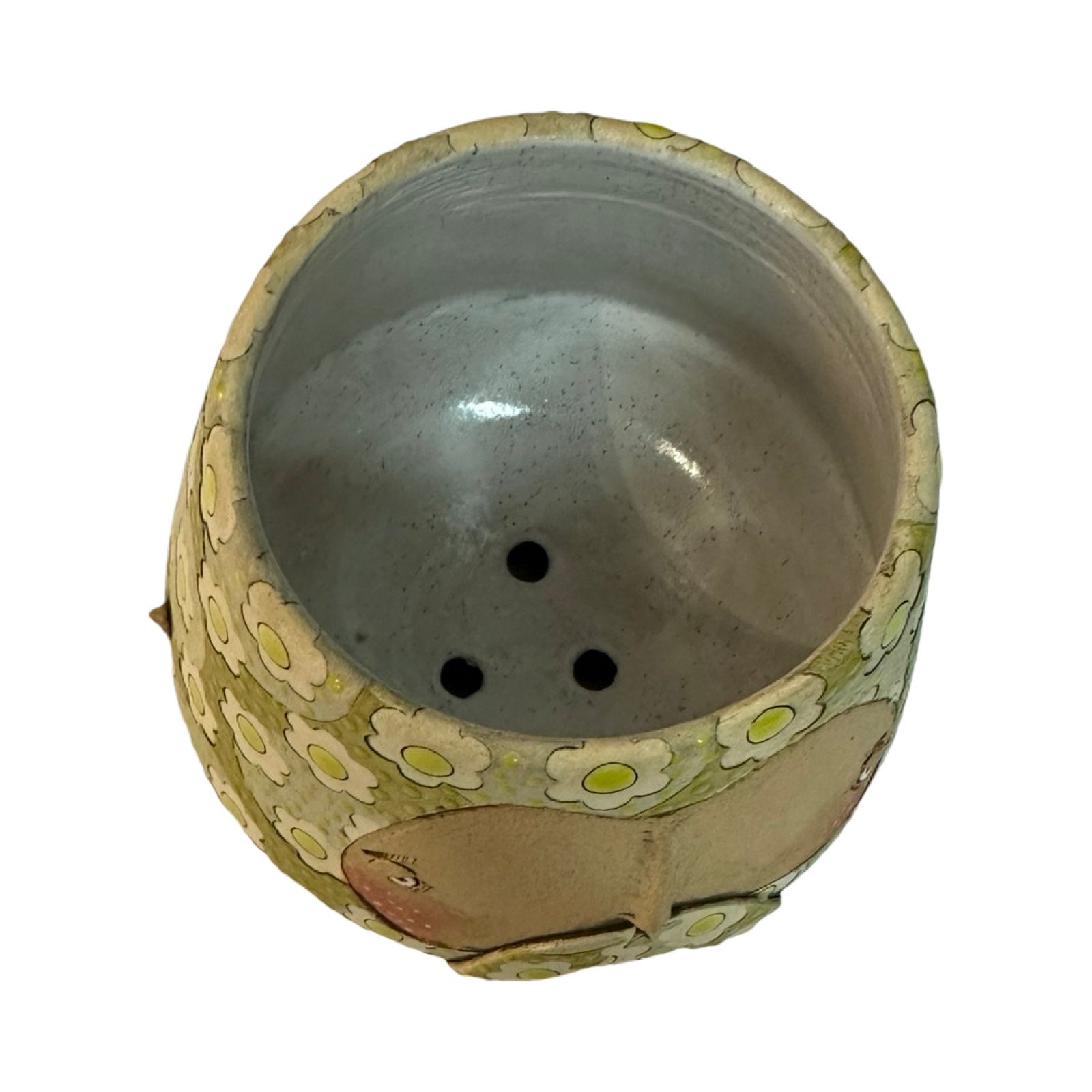 This moustache-faced planter is glazed in green with a lighter green floral pattern.