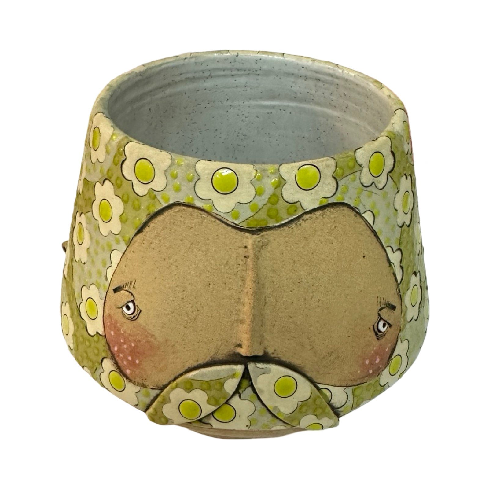 This moustache-faced planter is glazed in green with a lighter green floral pattern.
