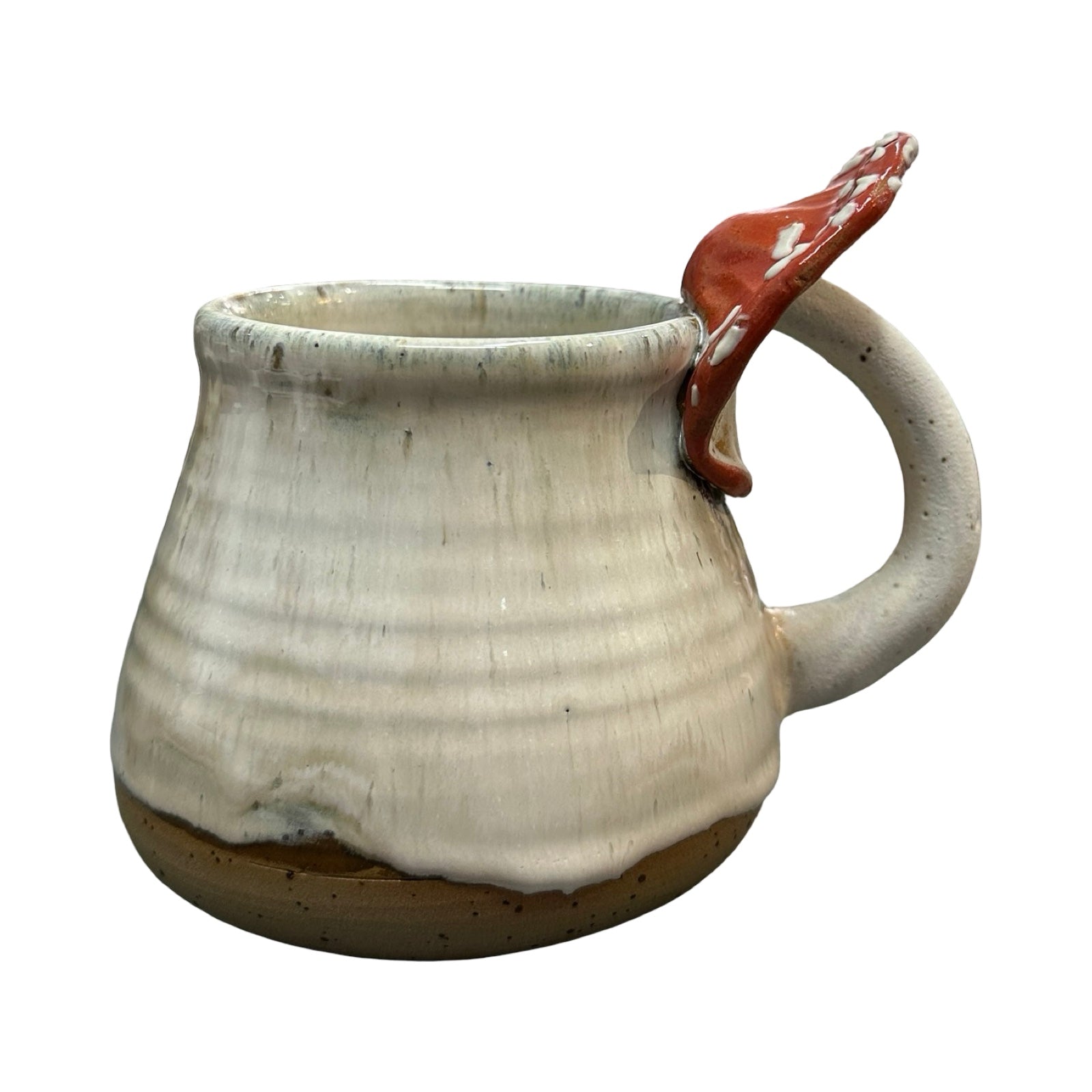 White ceramic mug with a red mushroom handle on a white background.