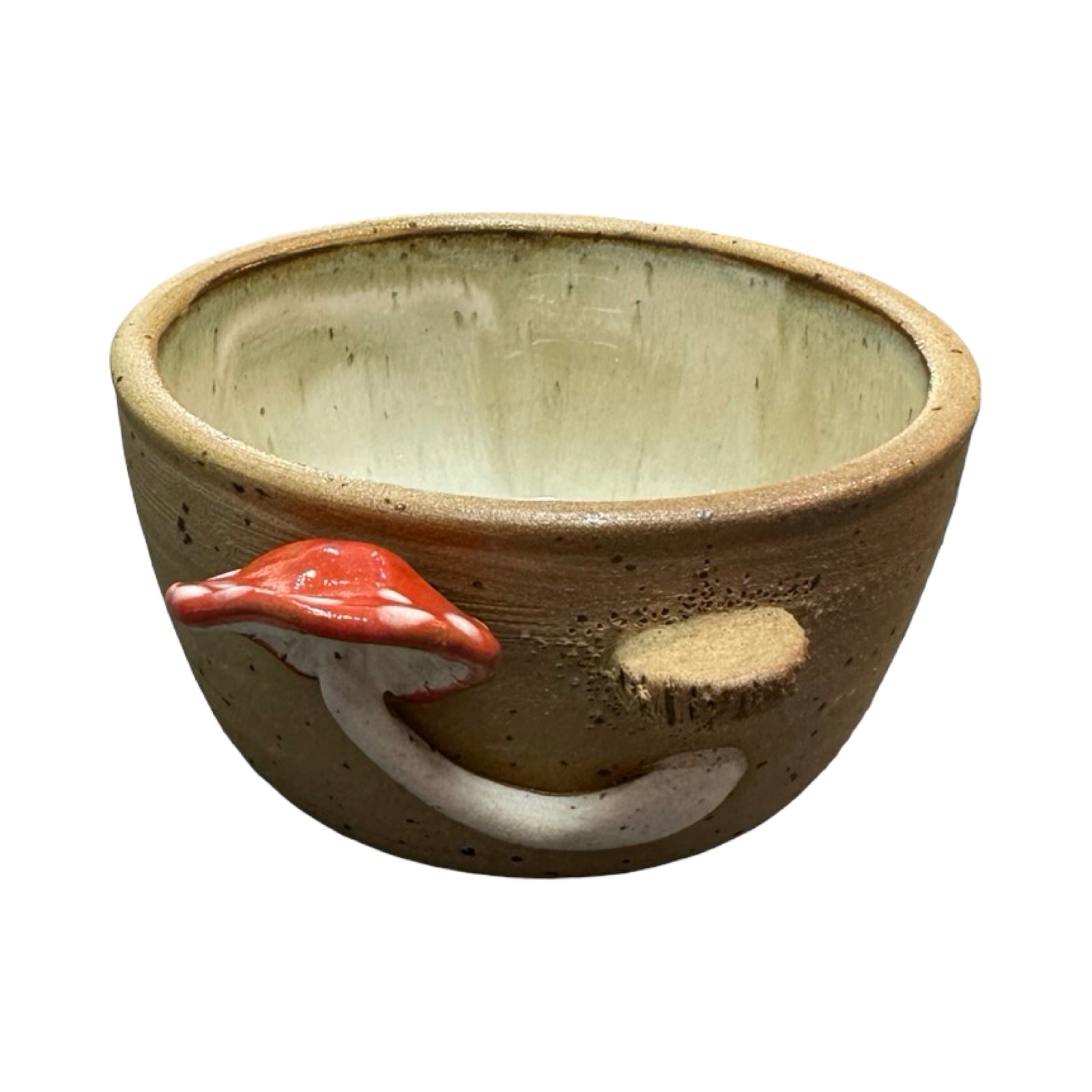Ceramic trinket dish with a red mushroom design on a white background.