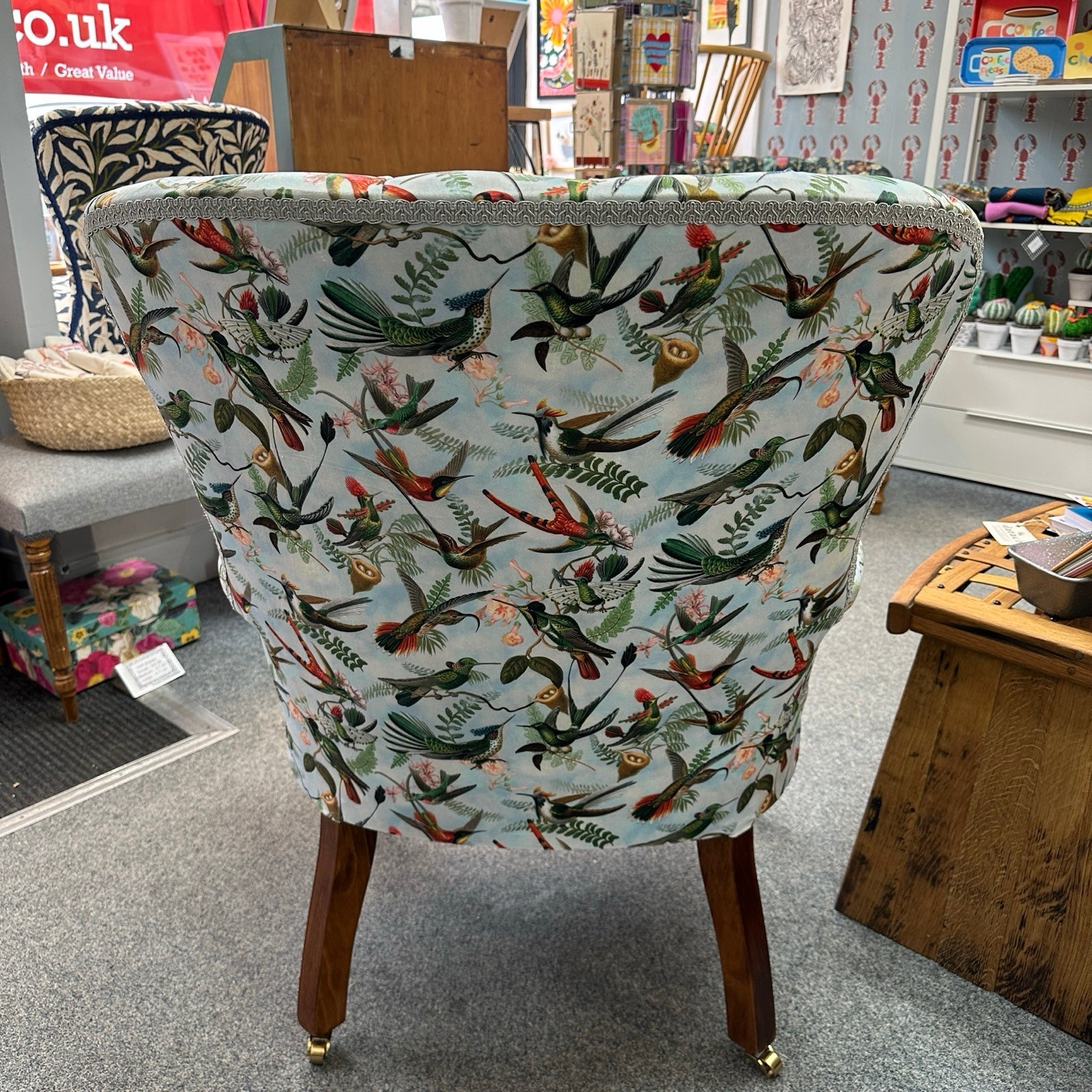 Chair with bird and floral pattern in a store.