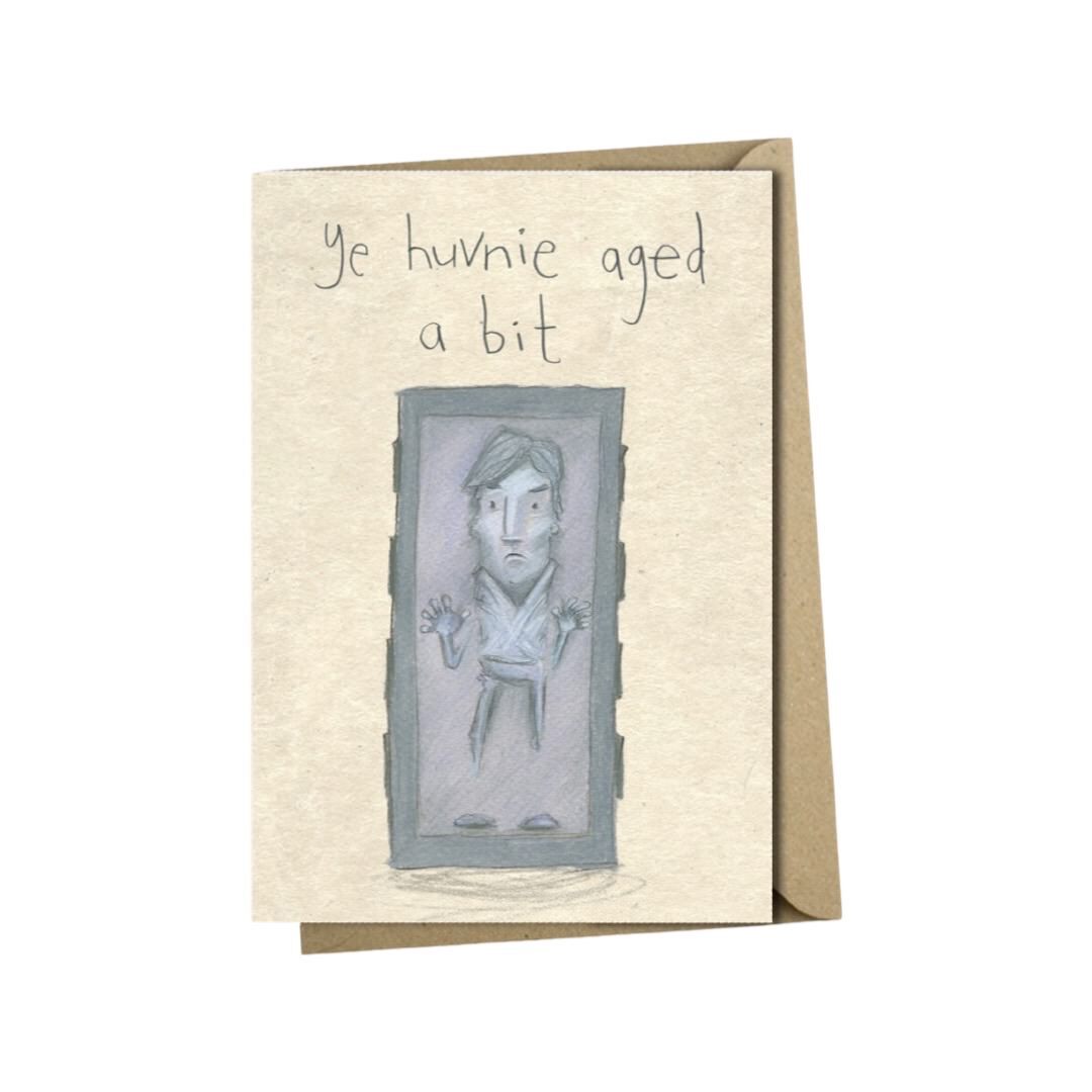 Birthday card featuring an illustration of a young Han Solo frozen in carbonite and the text 'Ye Huvnie Aged A Bit'.