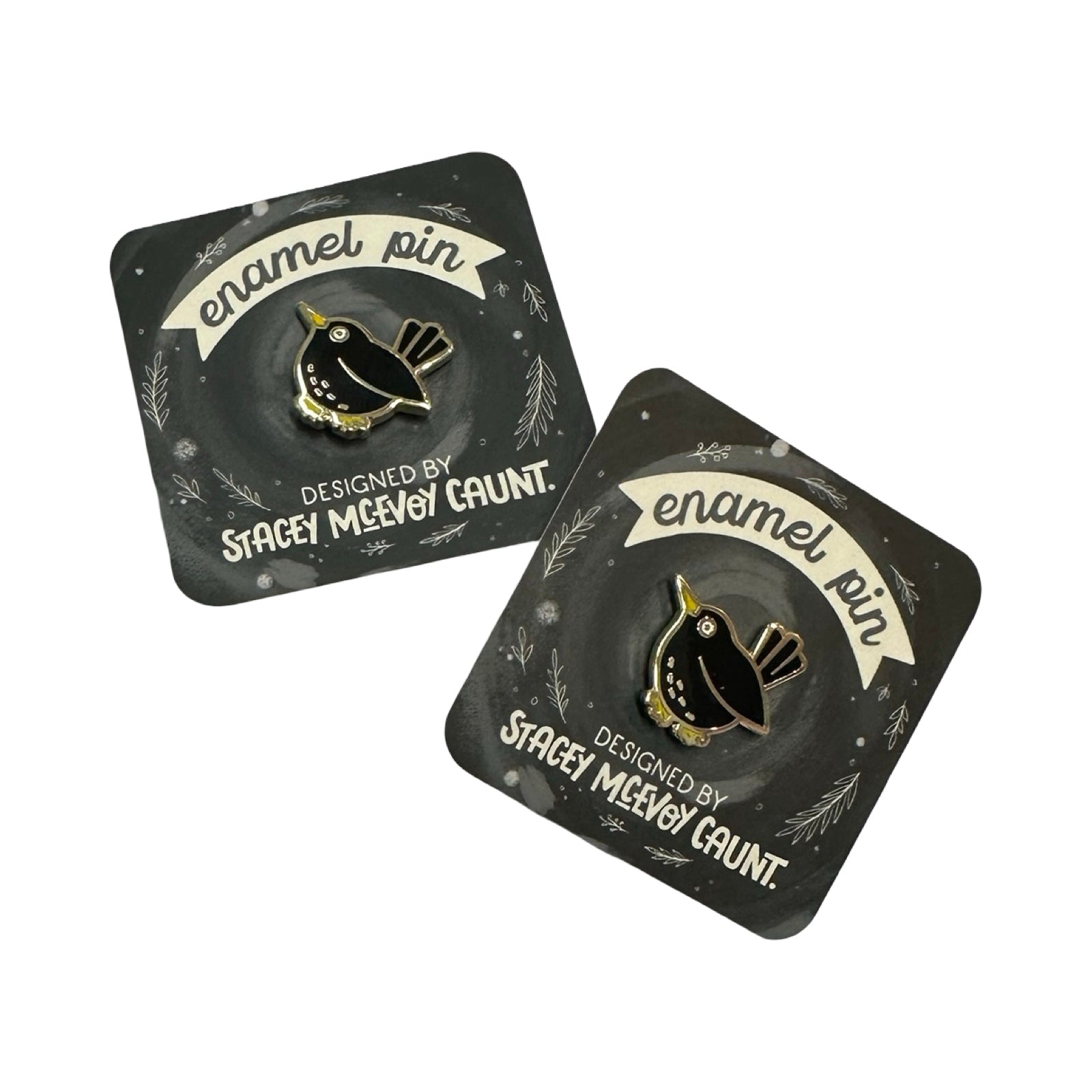 Two black cards with bird enamel pins and 'Stacey McEvoy Caunt' branding on a white background.