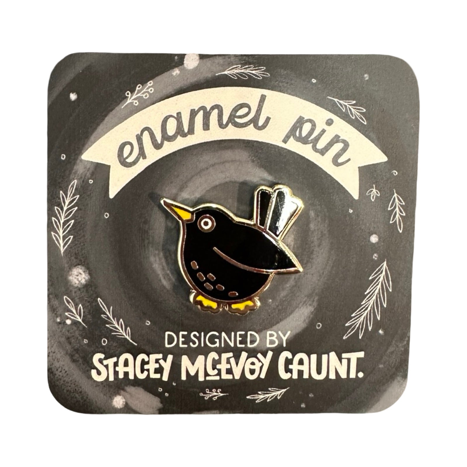 Enamel pin packaging with a bird design and text about the artist.