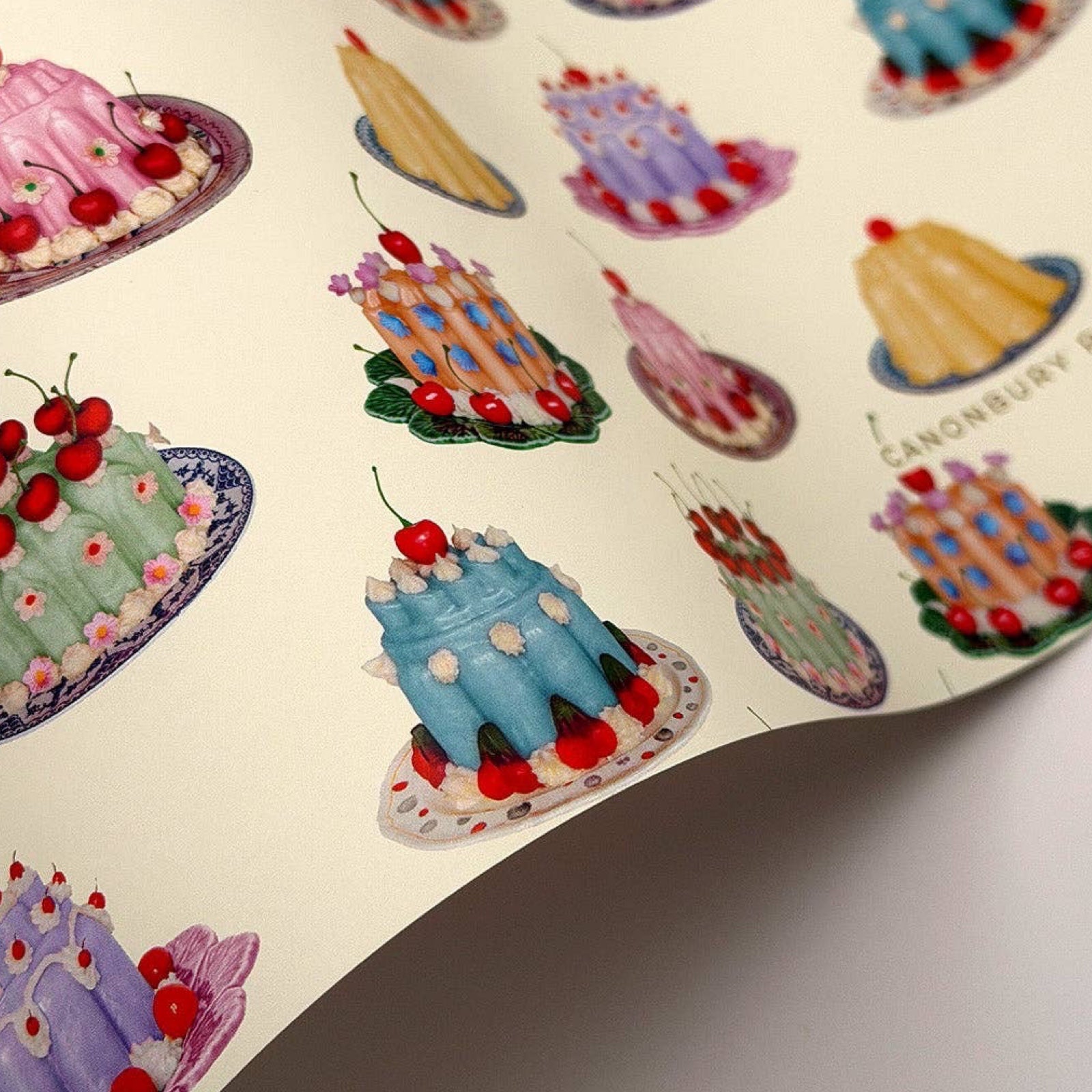 Colorful cake wrapping paper with various designs on a beige background.