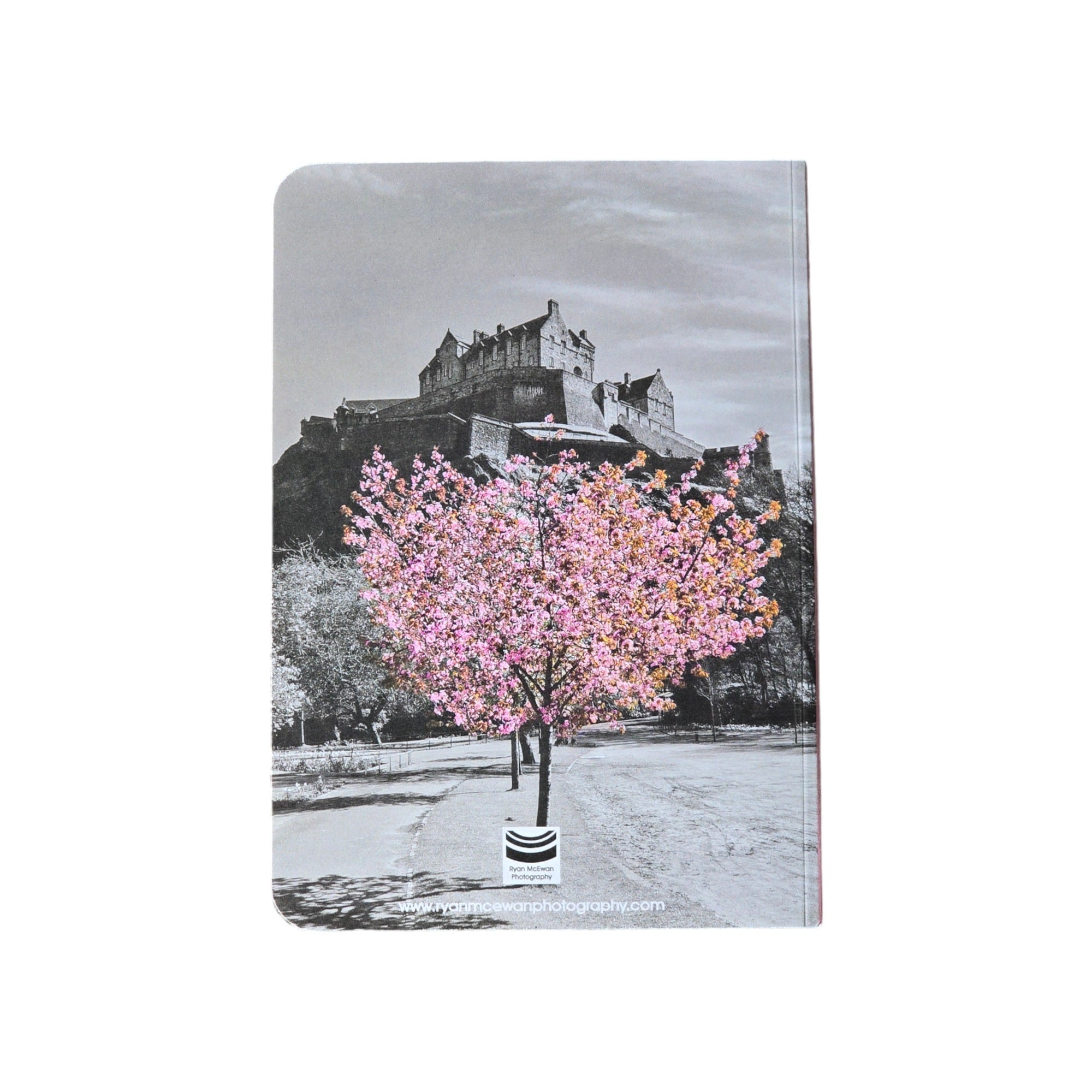 the back of notebook with an image of Edinburgh Castle in black and white with a tree with pink blossom in the foreground on the cover of a notepad.