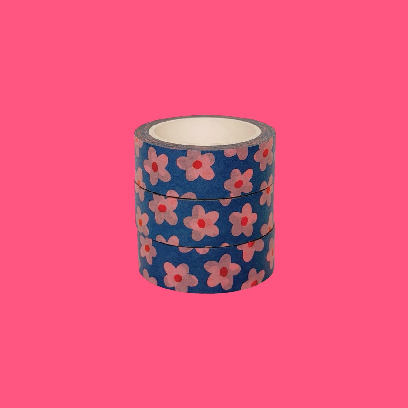 Three rolls of floral-patterned tape on a pink background.