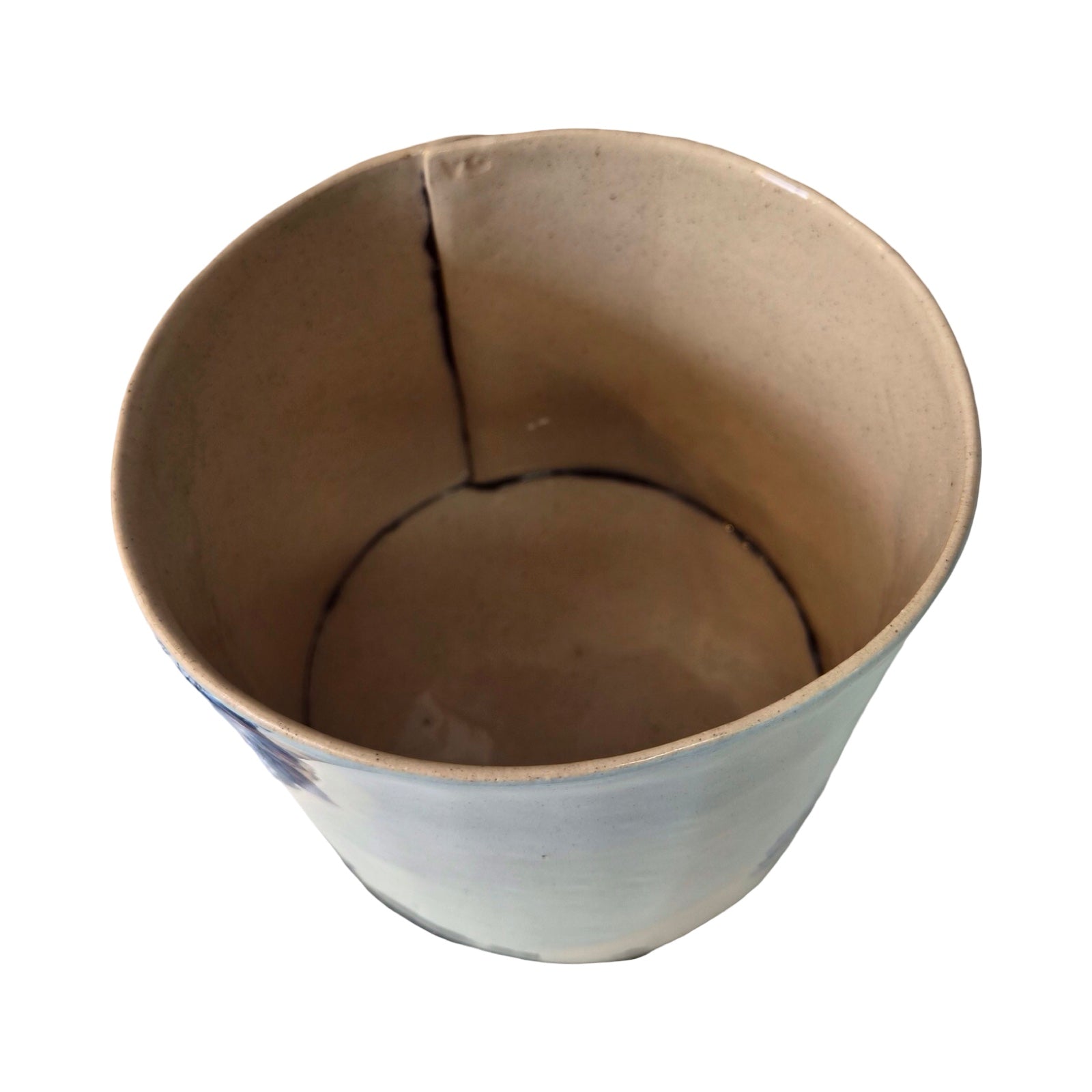 Inside of ceramic planter on a white background.