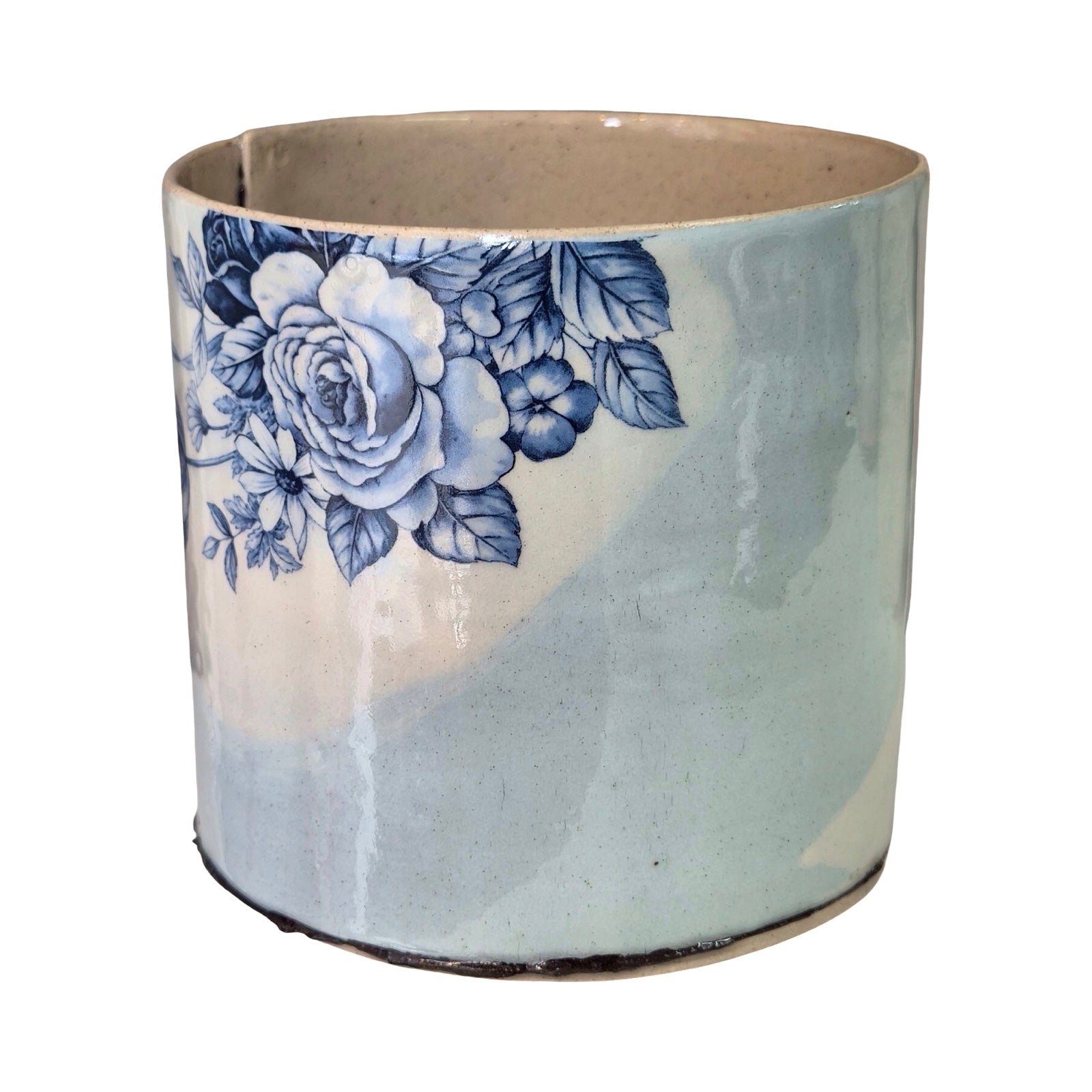 Ceramic planter with blue floral design on a white background.