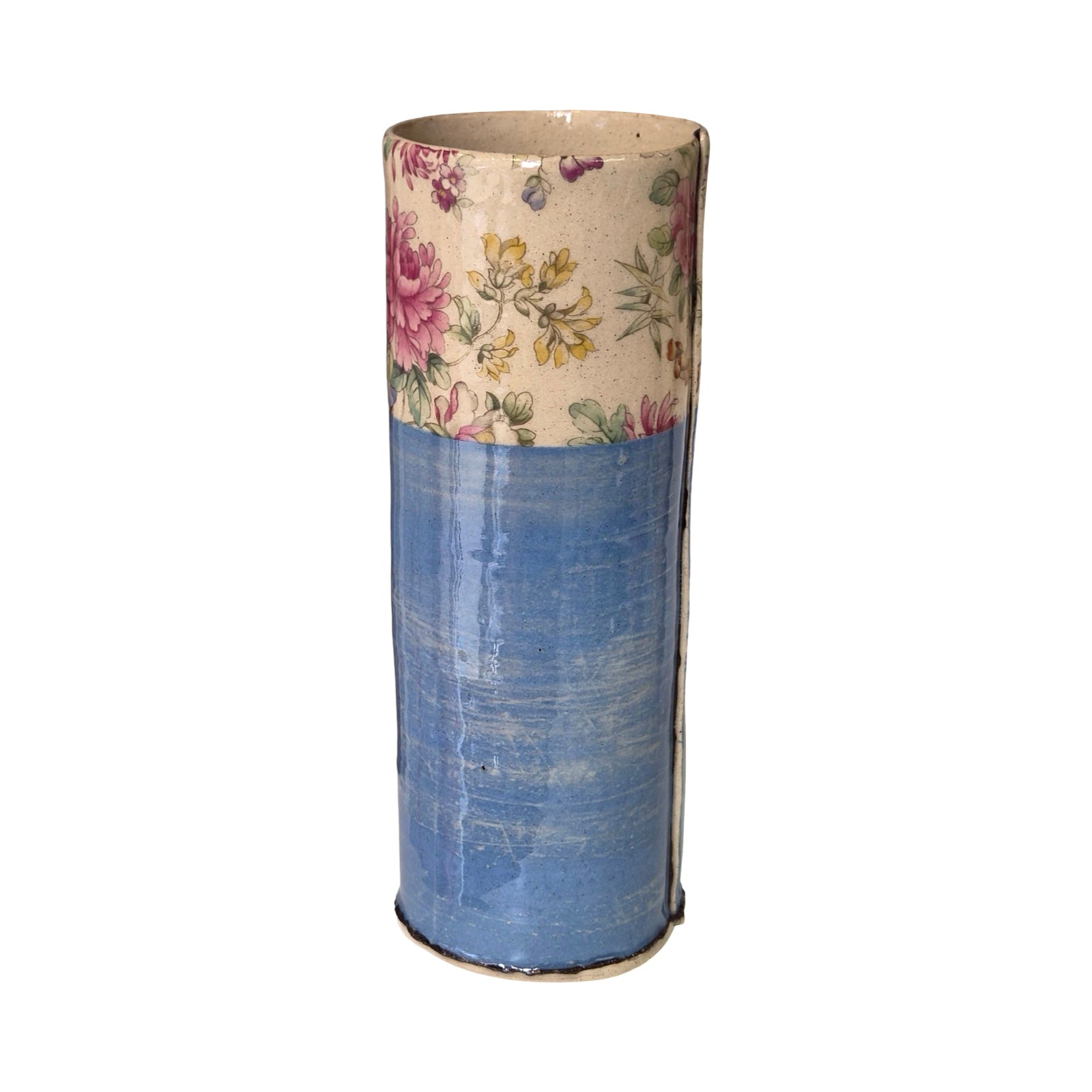 Cylindrical vase with floral top section and blue bottom section on a white background.