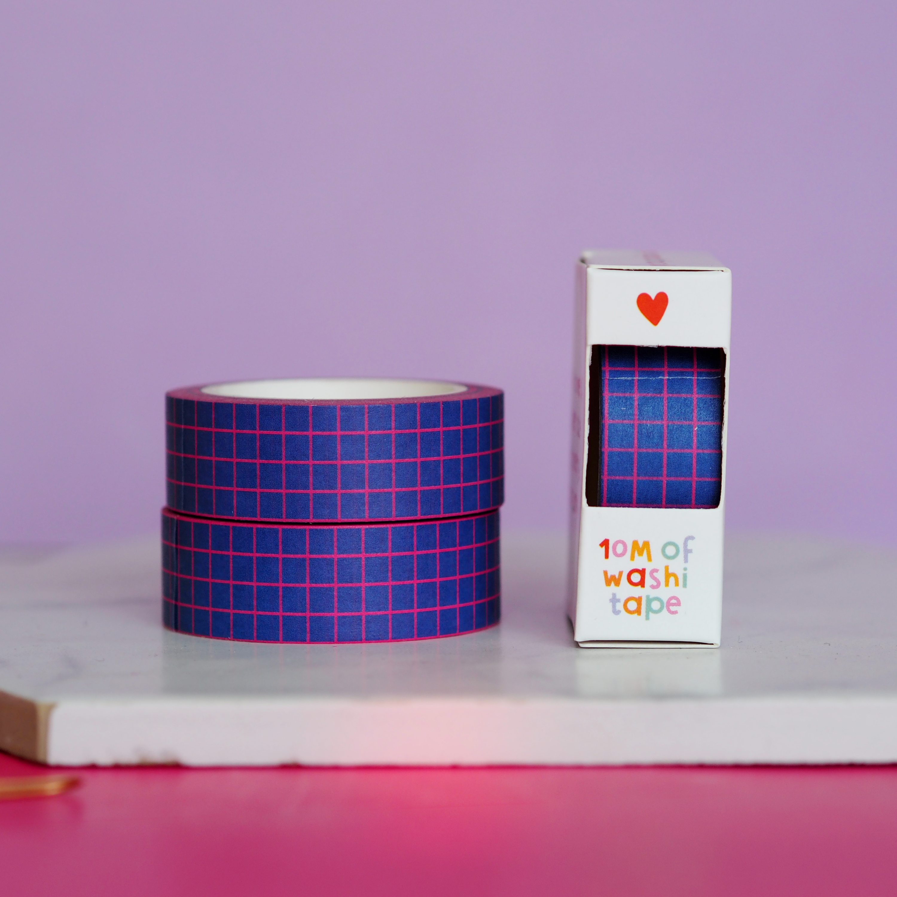 Blue checkered washi tape with packaging on a purple background.