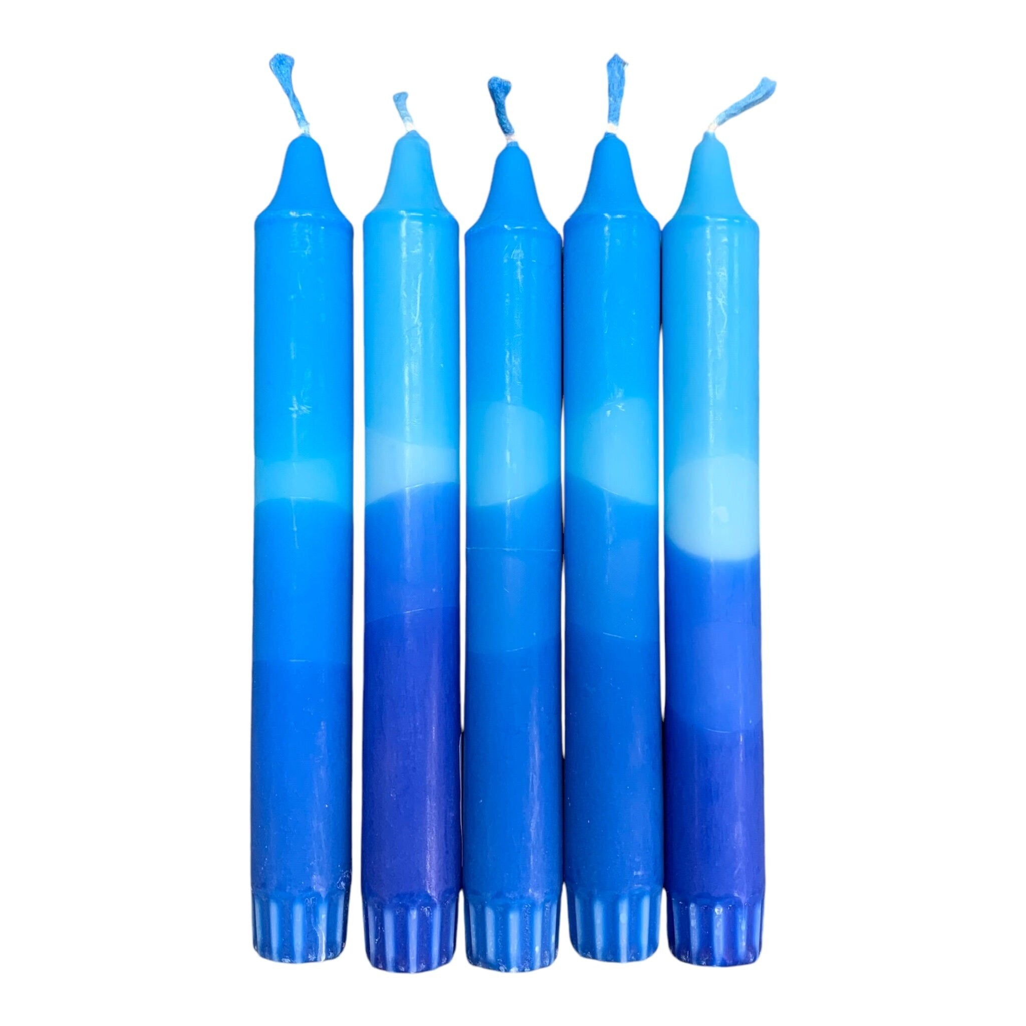 A row of 5 handmade dinner candles with a dark blue base and lighter blue top.