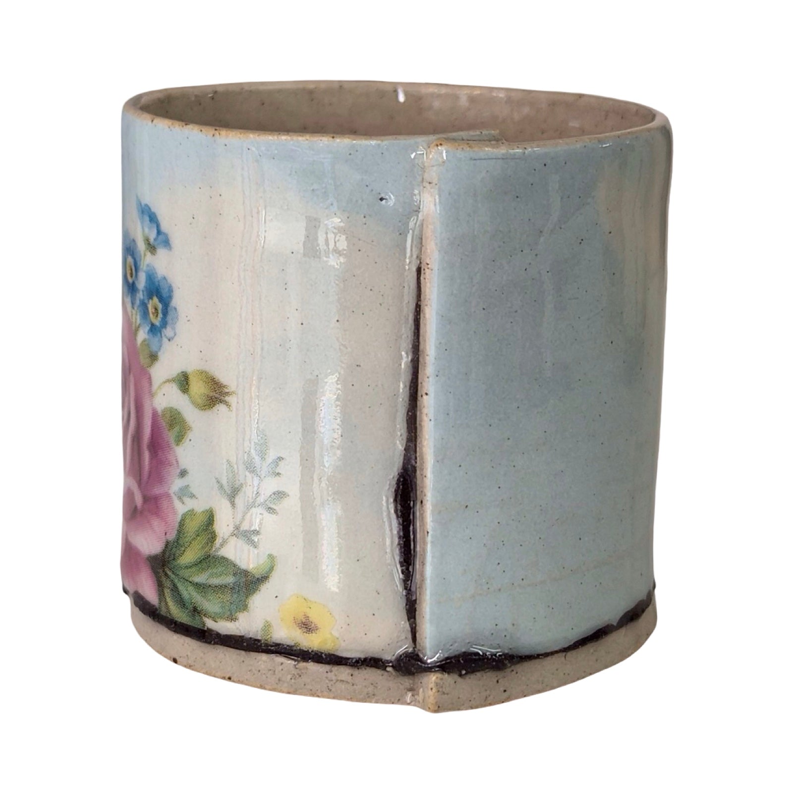 Ceramic planter with floral design on a white background.