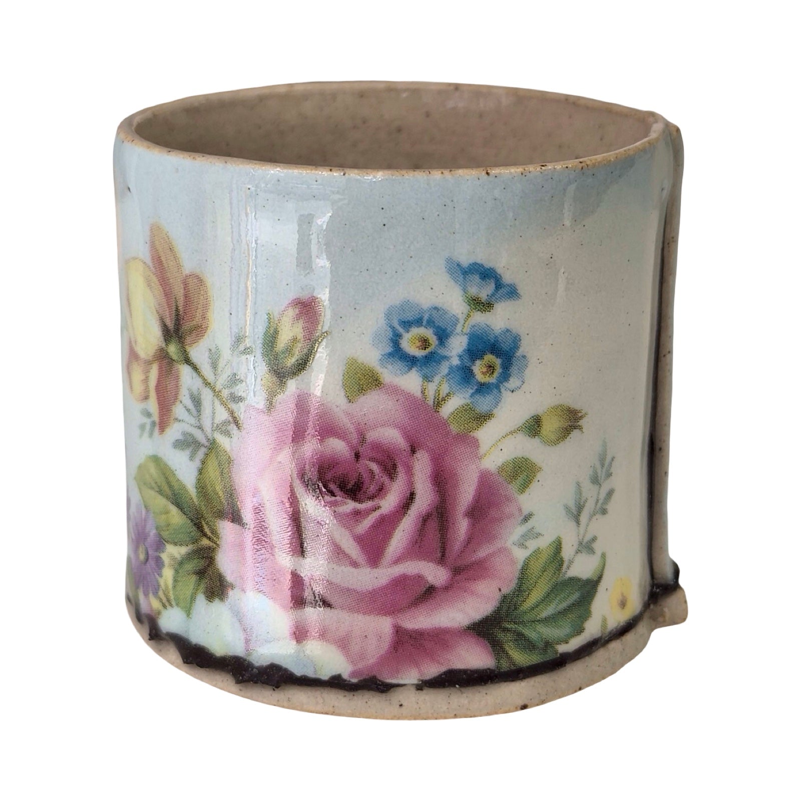 Ceramic planter with floral design on a white background.