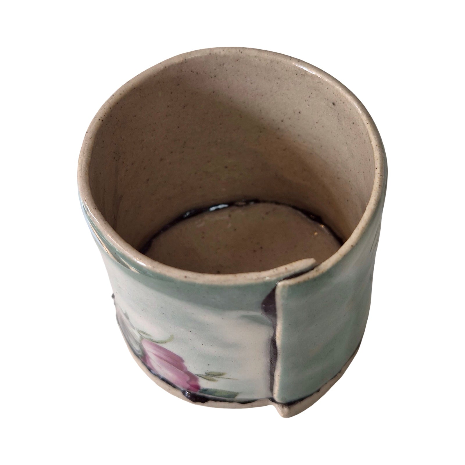 Ceramic planter with floral design on a white background.