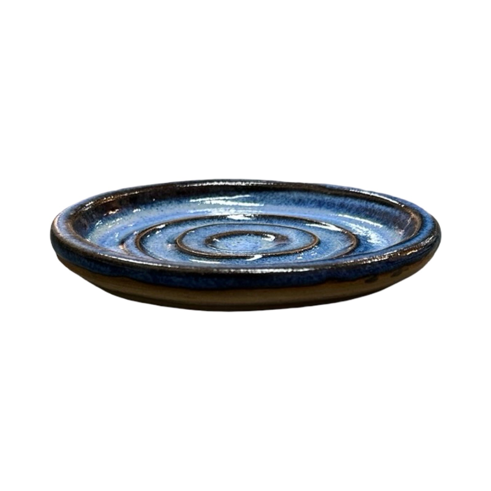 Ceramic dish with blue glaze on a white background.