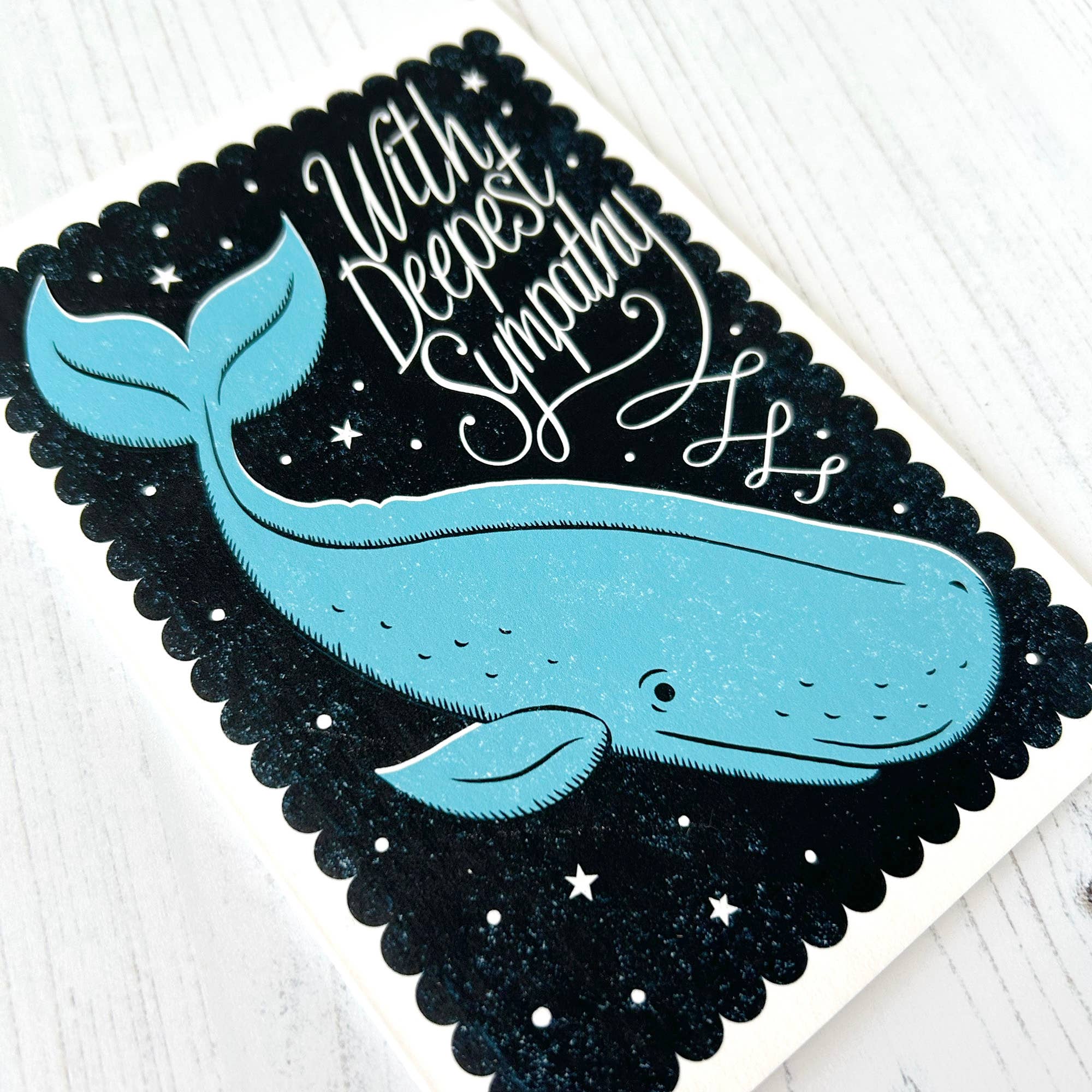 Card with a blue whale illustration and 'With Deepest Sympathy' text on a black border.