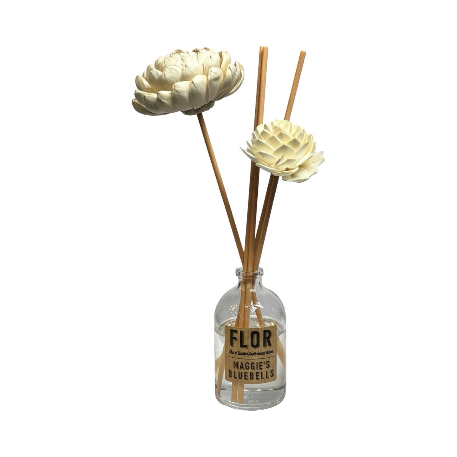 Decorative diffuser with flowers and sticks in a clear bottle labeled 'FLOR'.