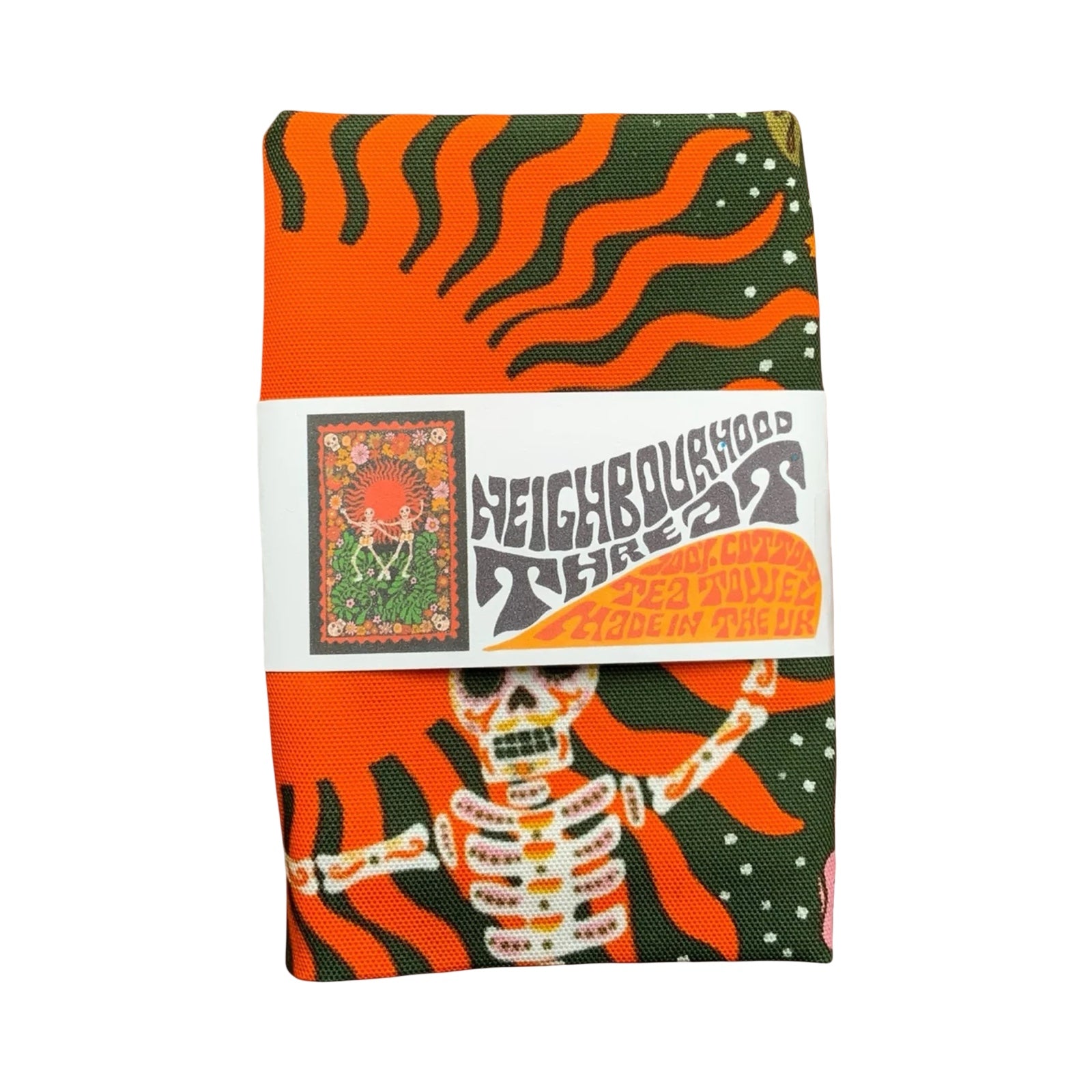 A statement tea towel featuring skeletons dancing on a green and orange background, packaged with a band.
