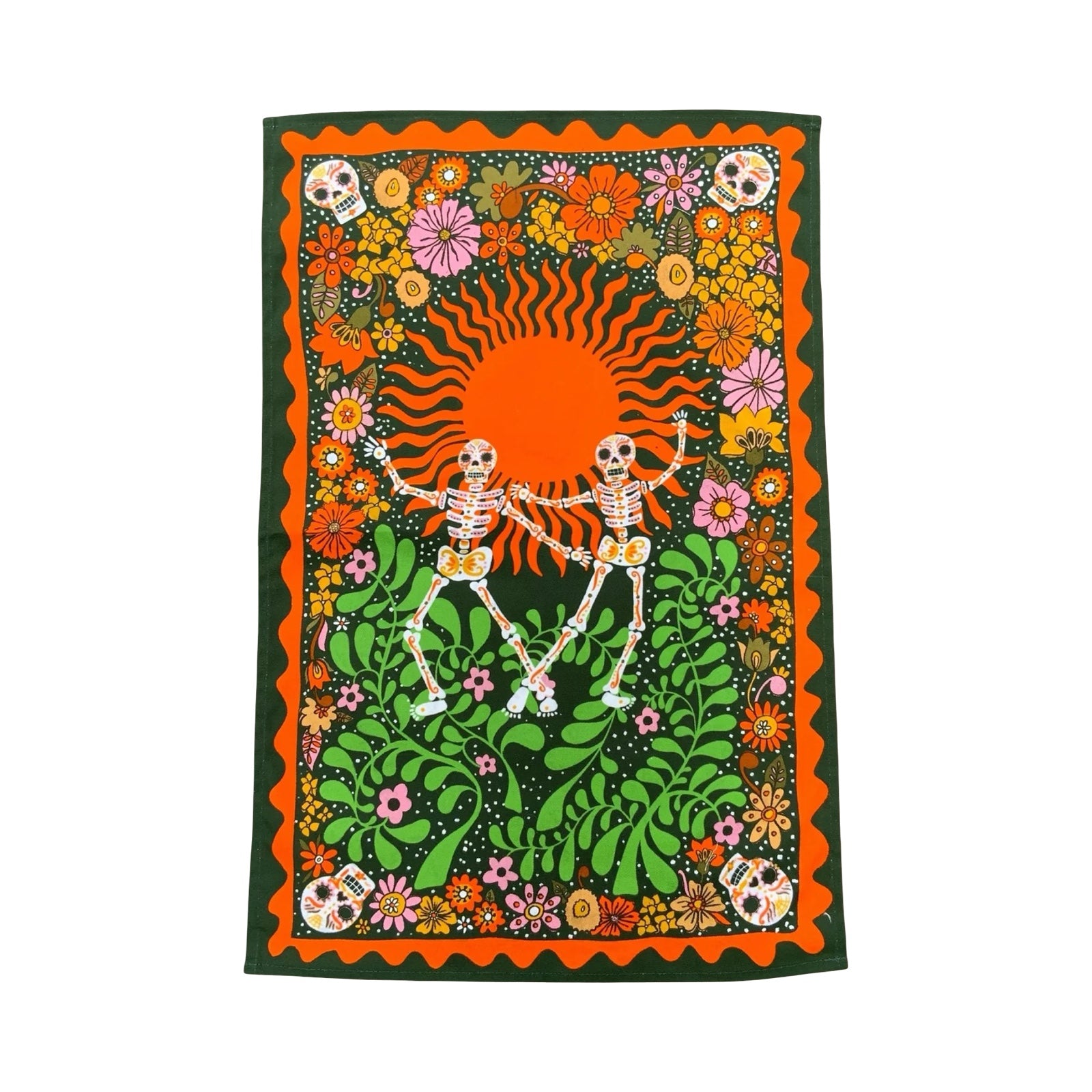 A statement tea towel featuring skeletons dancing on a green and orange background, with multicoloured flowers and skulls.