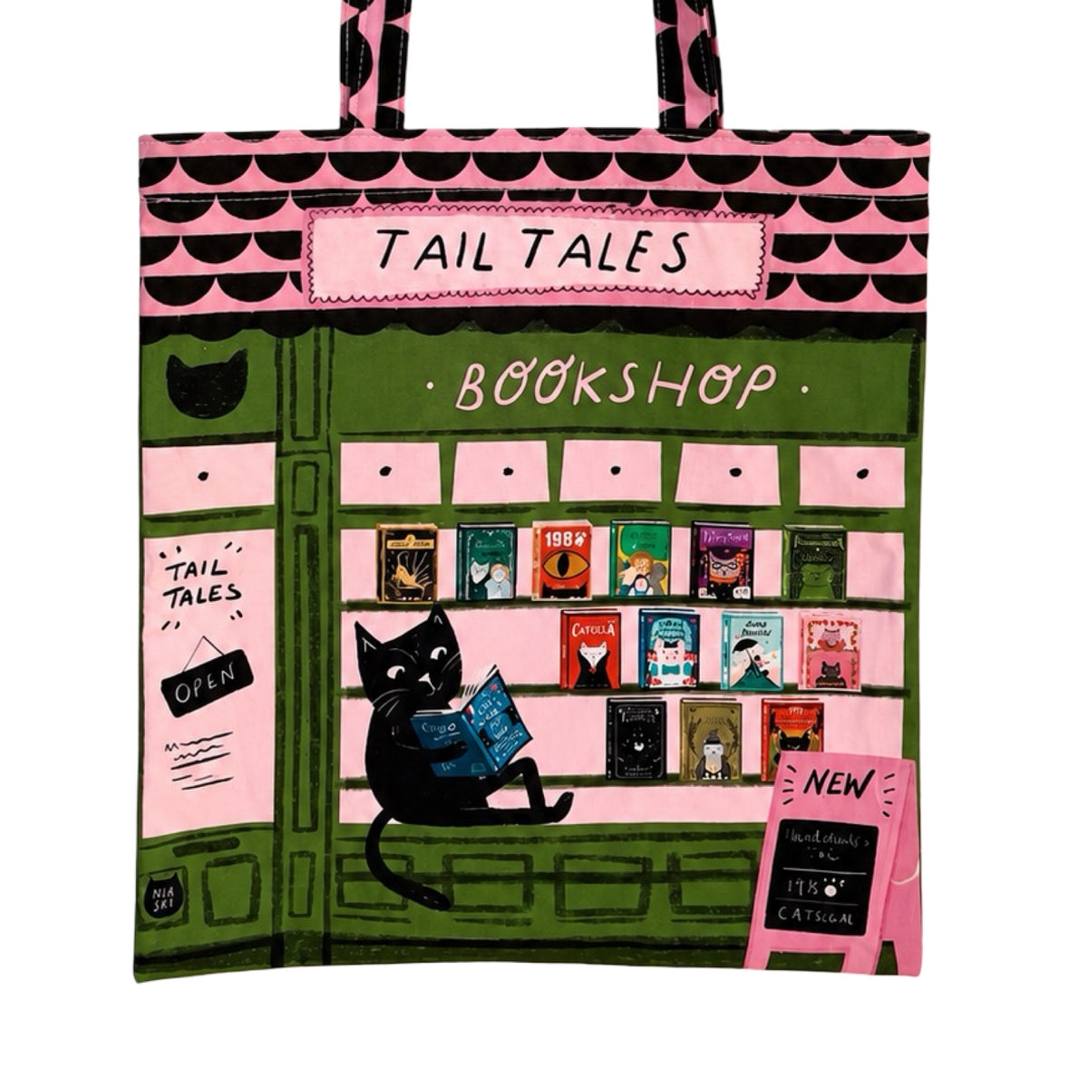 A pink and green tote bag featuring a whimsical illustration of a bookshop storefront with the text 'TAIL TALES BOOKSHOP', a black cat reading a book, and several colorful book covers displayed on shelves.