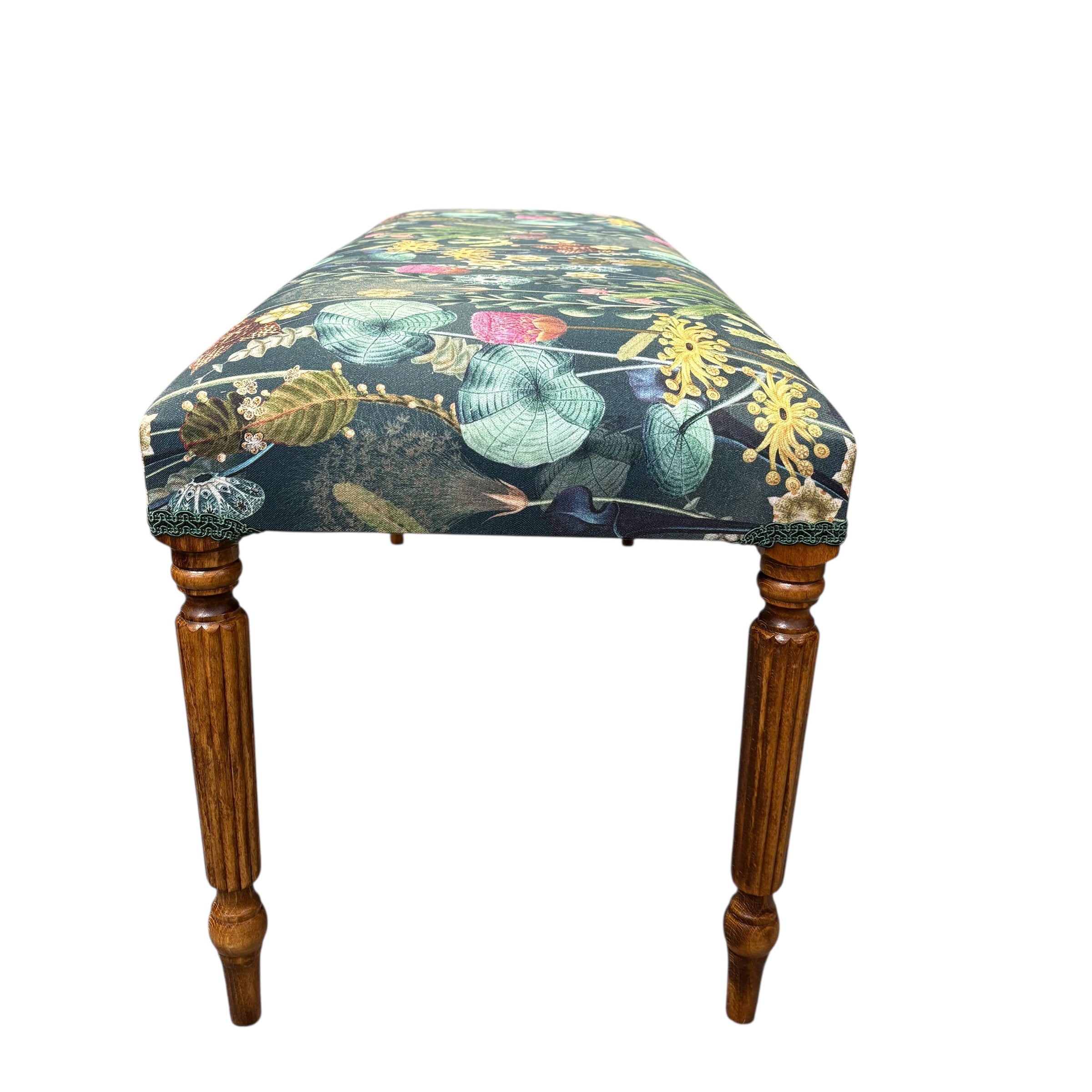 A beautiful hand crafted occasional bench, perfect for any lounge, conservatory or bedroom. Covered in a dark green cotton featuring a botanical scene in dark green fabric with mahogany stained legs. 