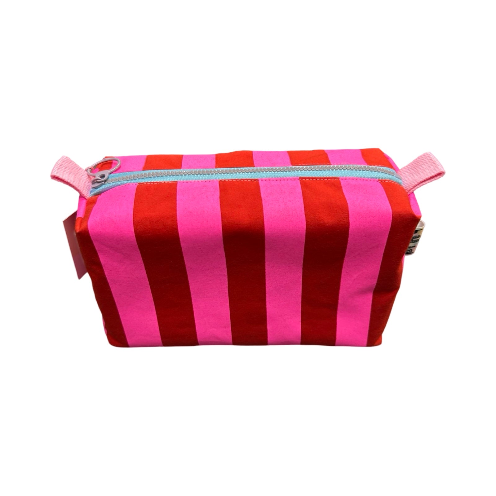 A boxy cosmetic bag in red and bright pink stripes.