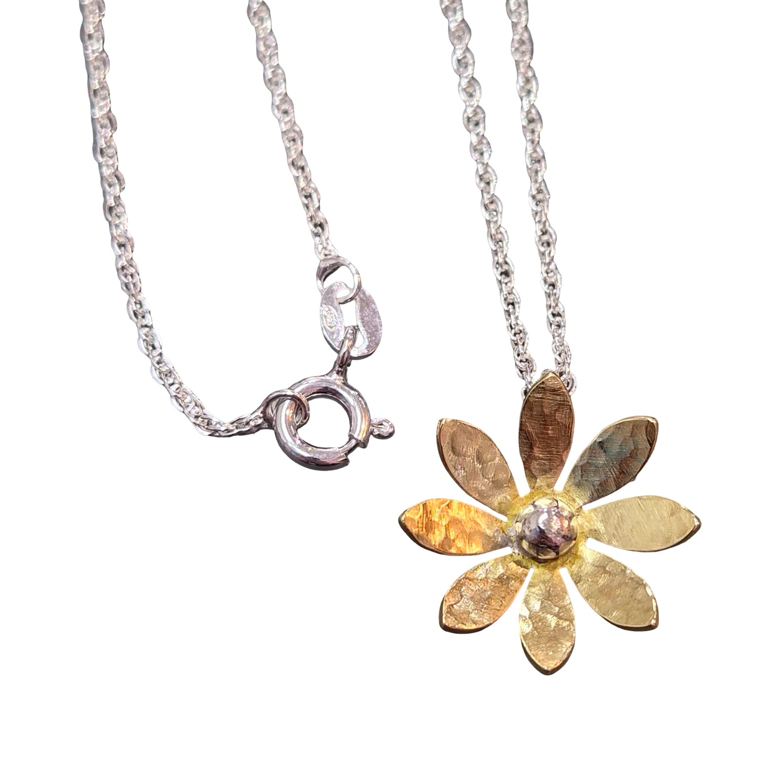 Gold flower-shaped pendant on a silver chain against a white background.