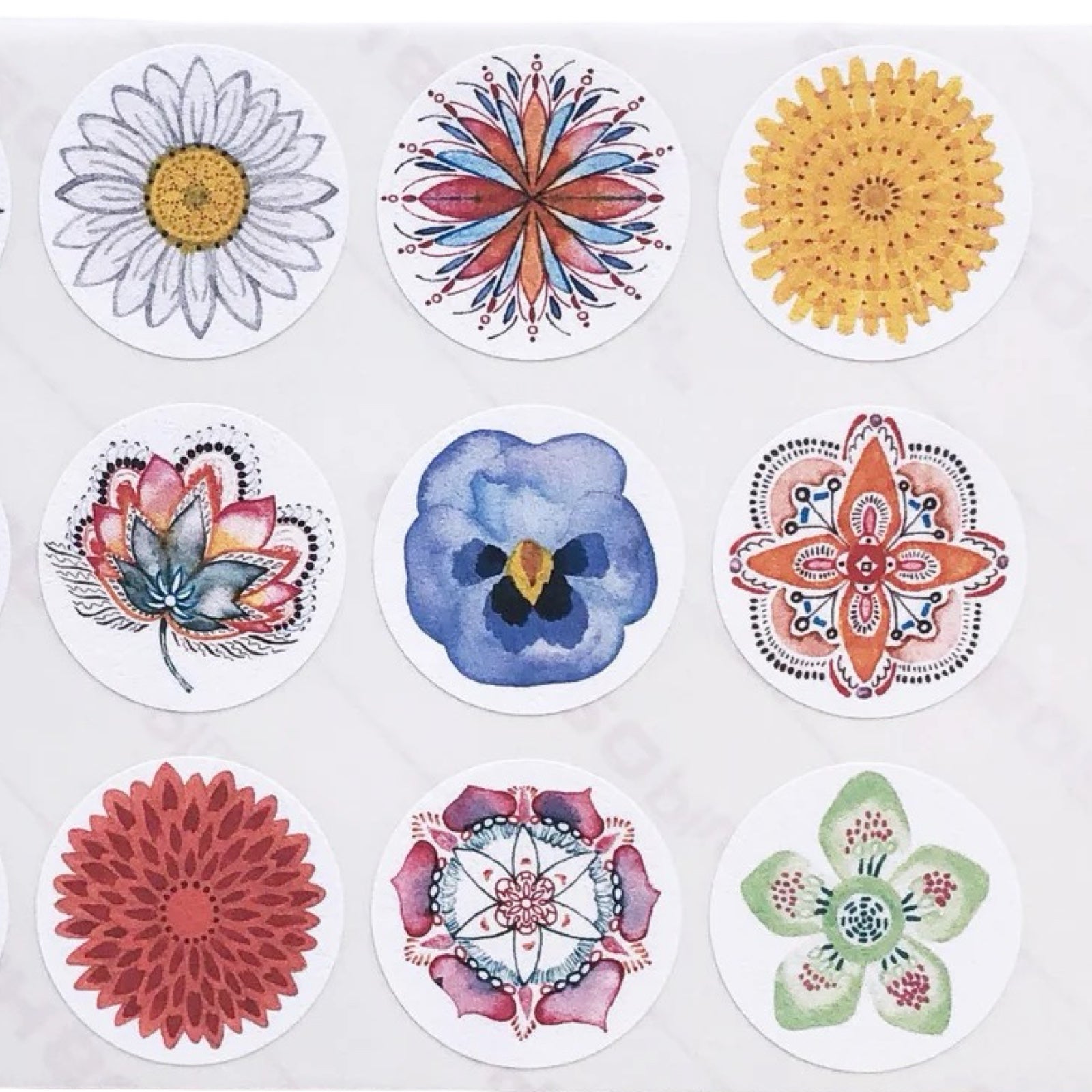 Set of colorful floral and geometric stickers on a white background.